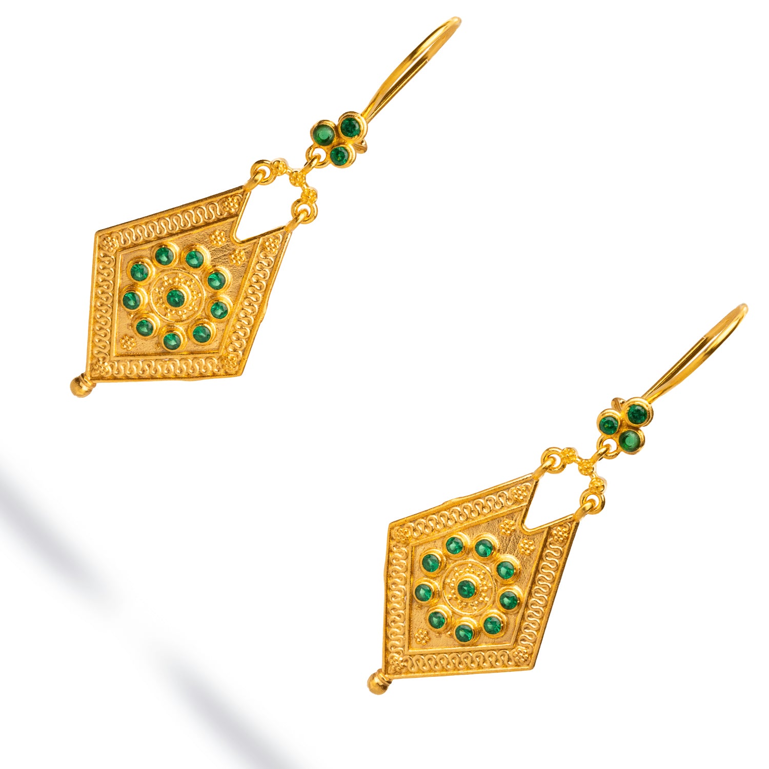 Sophisticated dangle earrings with 24k gold plating and vibrant emerald stones, designed to capture a classic vintage elegance.
