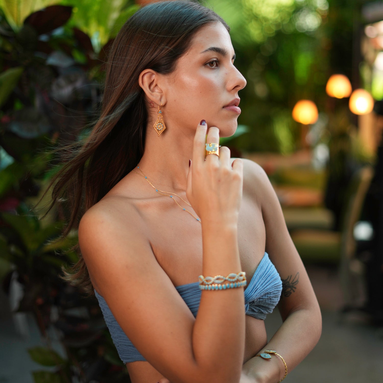 Vintage-style dangle earrings with 24k gold plating and turquoise stones, designed to add a luxurious and distinctive touch to your outfit.
