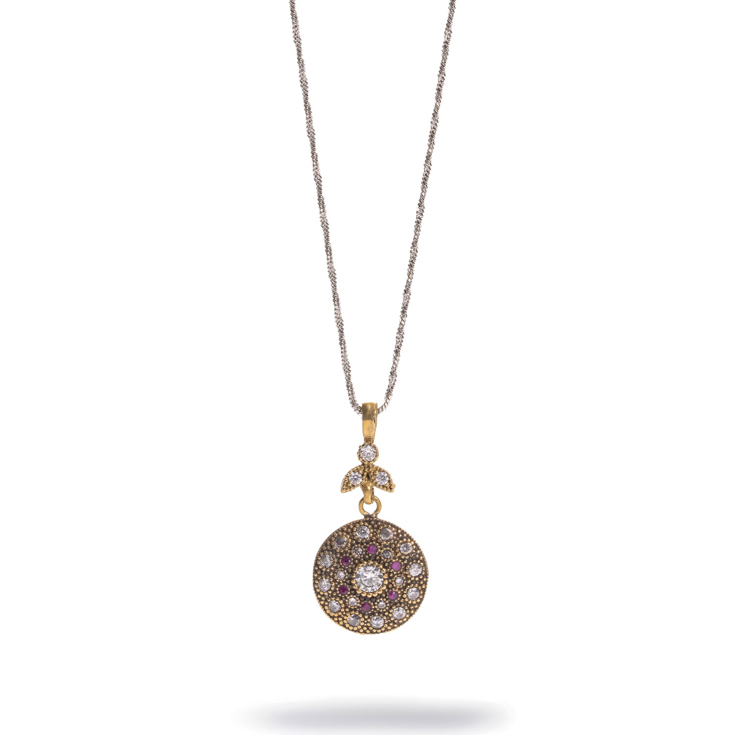 Vintage Style Ruby &amp; Zirconia Gold Medallion Necklace laid flat, round stone-set medallion on a fine silver-tone chain