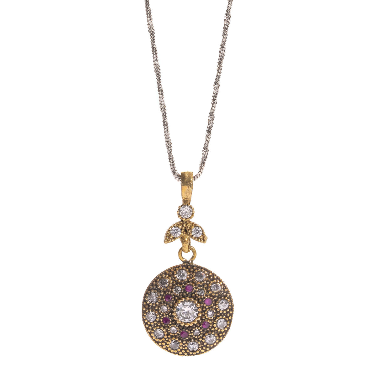 Close view of the vintage style gold medallion showing the central white zirconia stone, ruby accents and trefoil connector