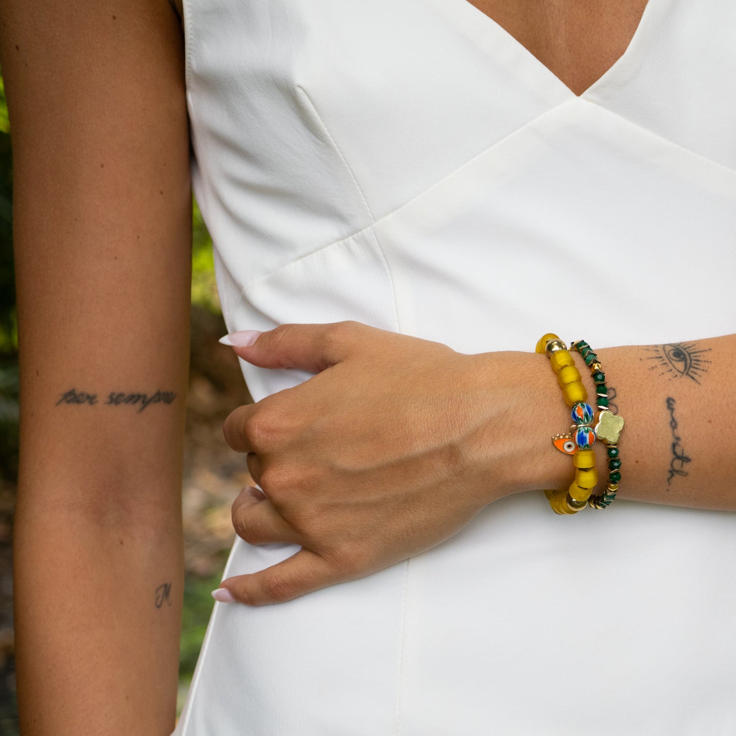 Vibrant handmade bracelet set with gold hematite and enamel evil eye charm.

