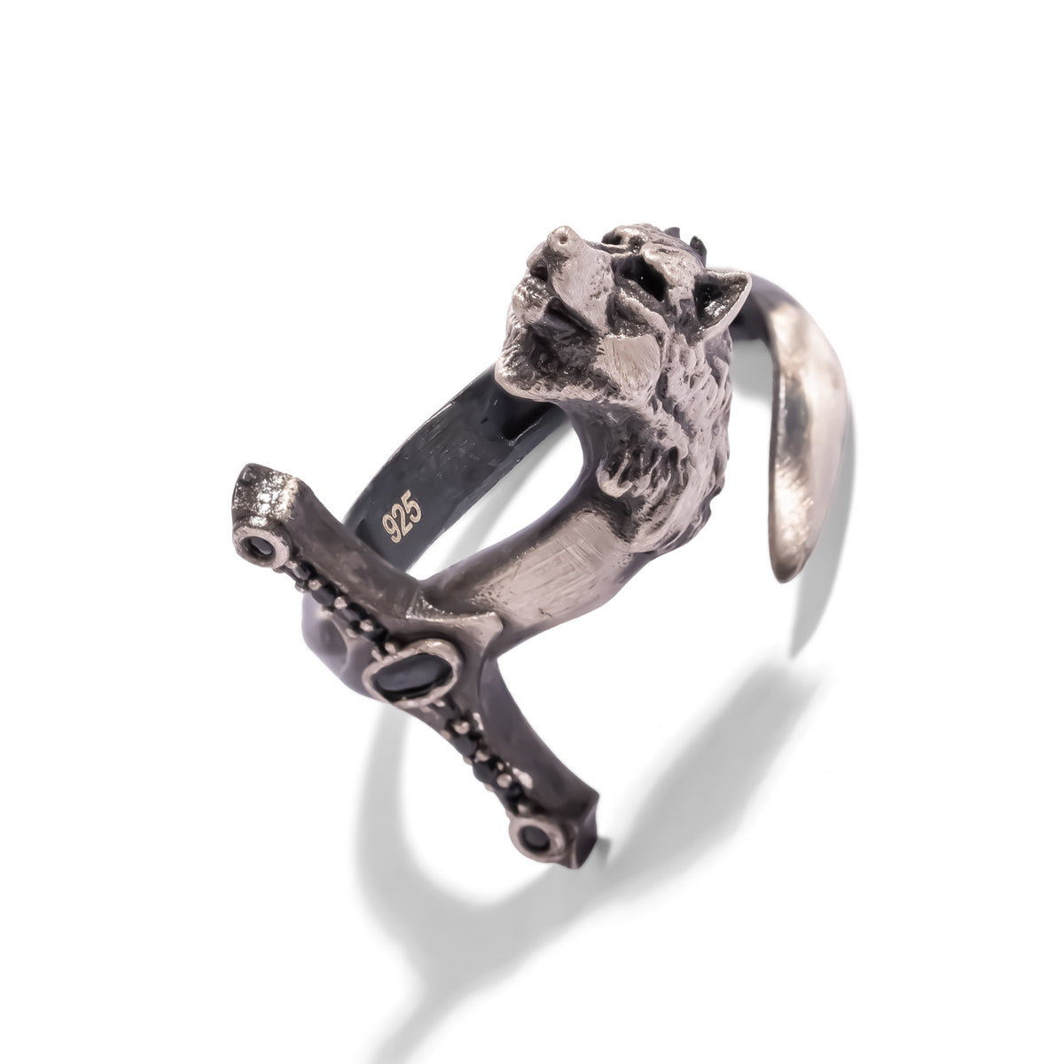 Side angle of the oxidized sterling silver wolf ring showing the open adjustable band and 925 stamp