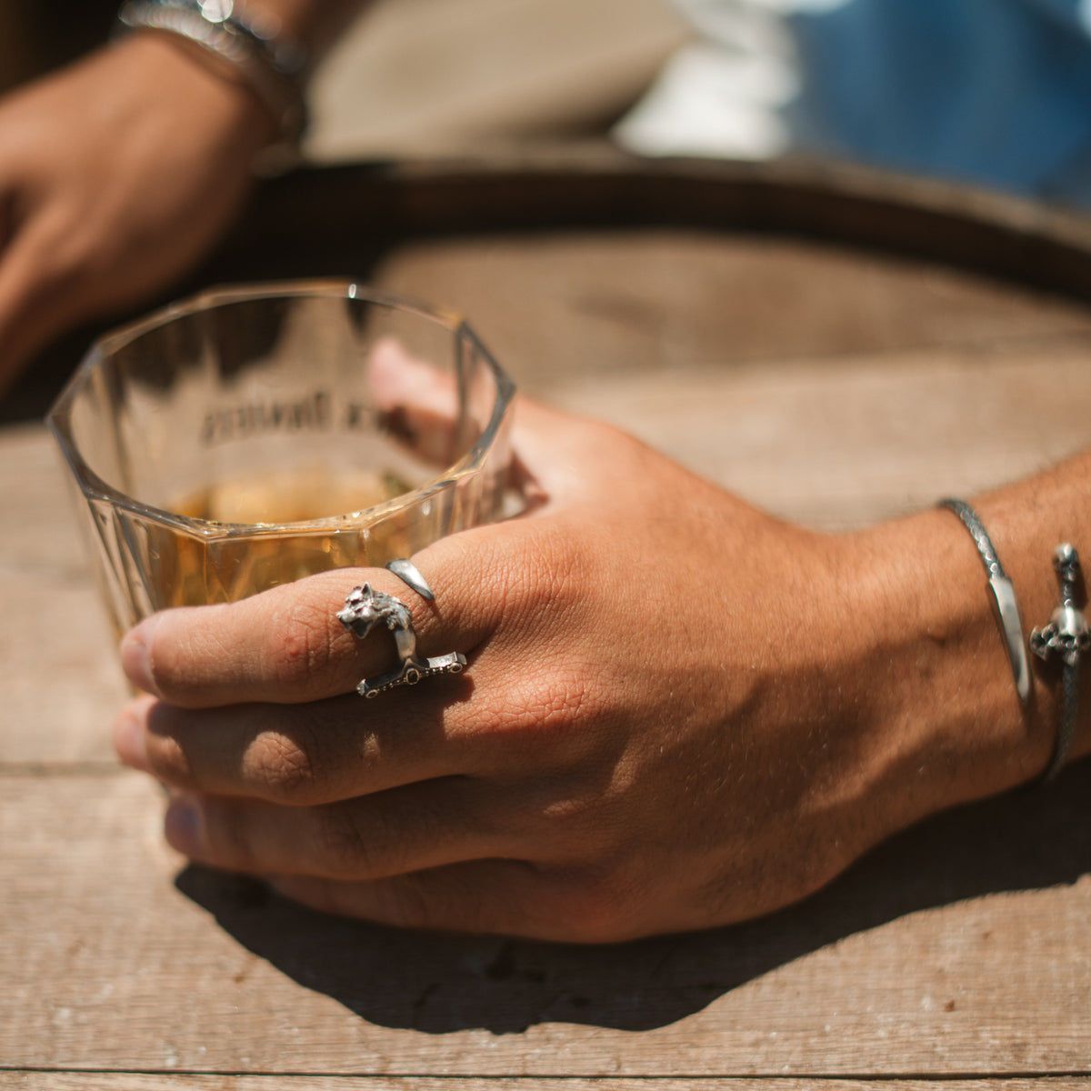 Wolf sword sterling silver men's ring worn on the index finger, styled with a silver cuff bracelet