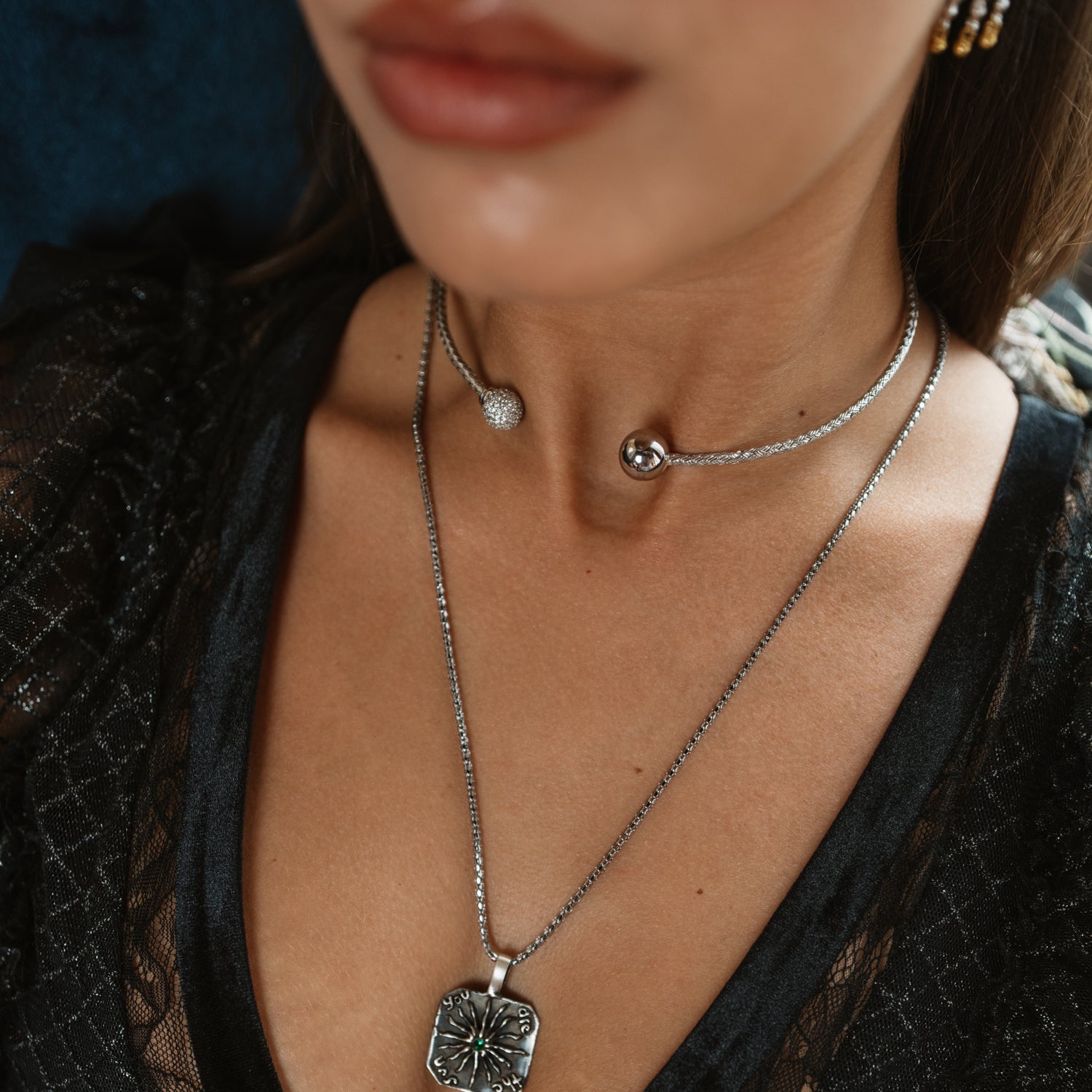 Sterling silver pave sphere choker necklace worn at the collarbone with a layered pendant necklace