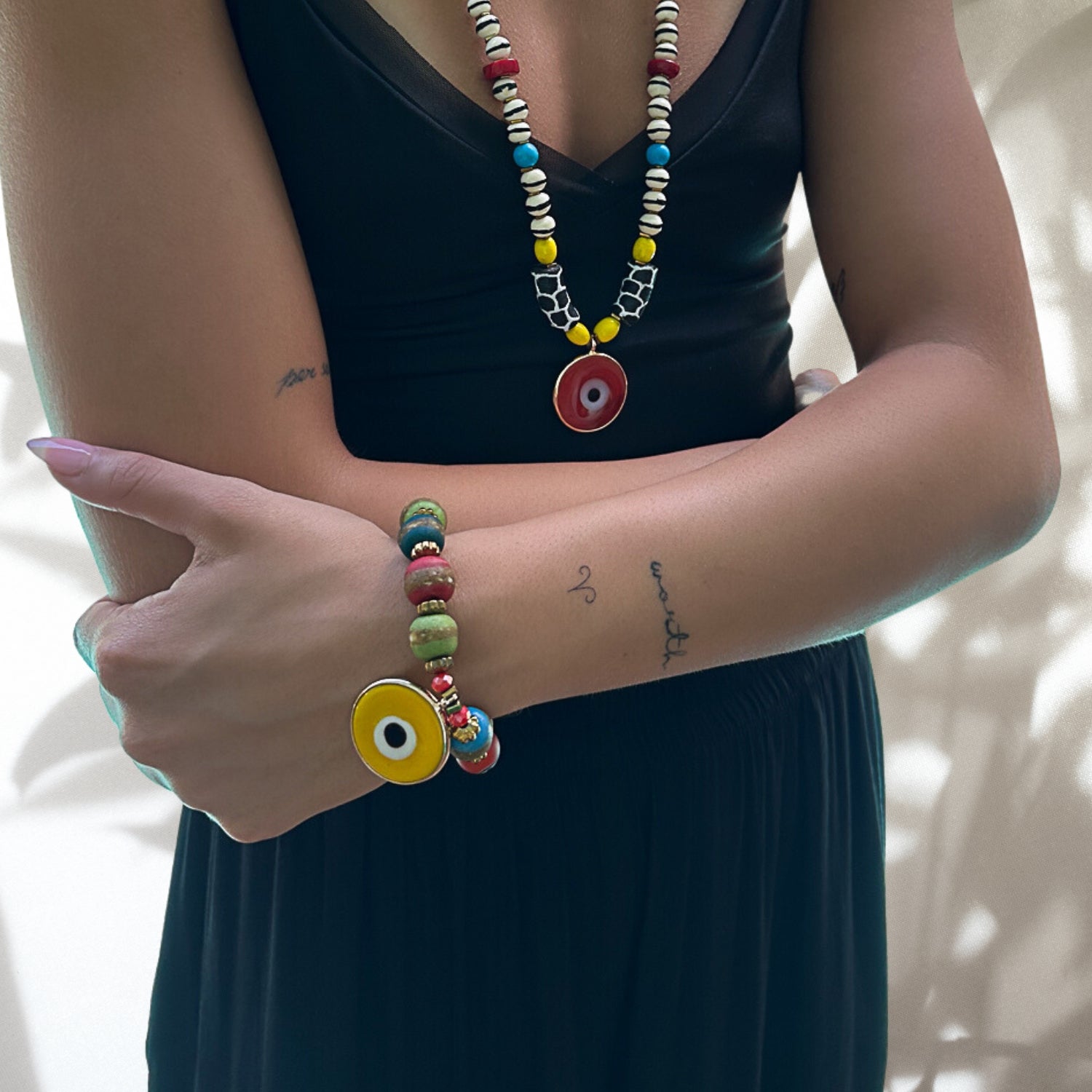 See how the Yellow Evil Eye Carpe Diem Bracelet adorns the hand model&#39;s wrist, adding a pop of color and reflecting her adventurous spirit.