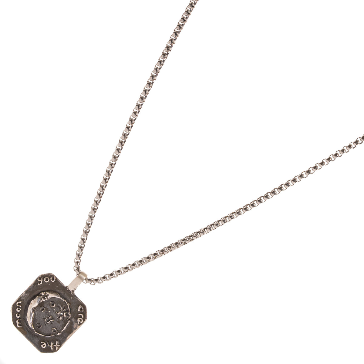 You Are The Moon sterling silver pendant at an angle, showing the engraved lettering around the raised crescent