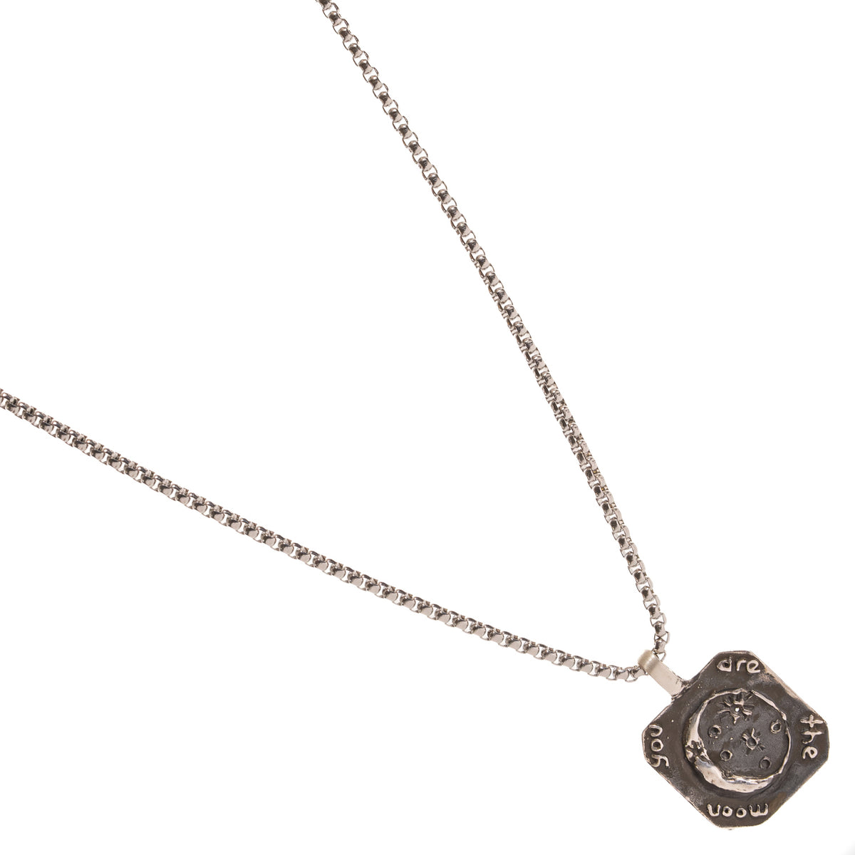 You Are The Moon engraved silver pendant and box chain laid diagonally, darkened silver around the crescent and stars