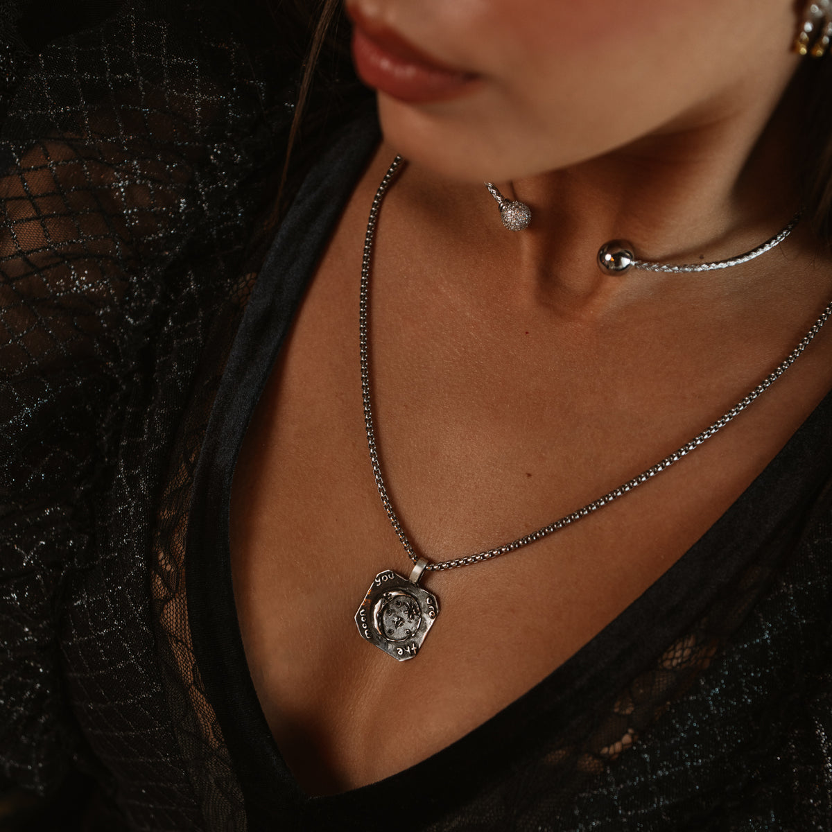 You Are The Moon sterling silver pendant worn on a box chain with a black lace top