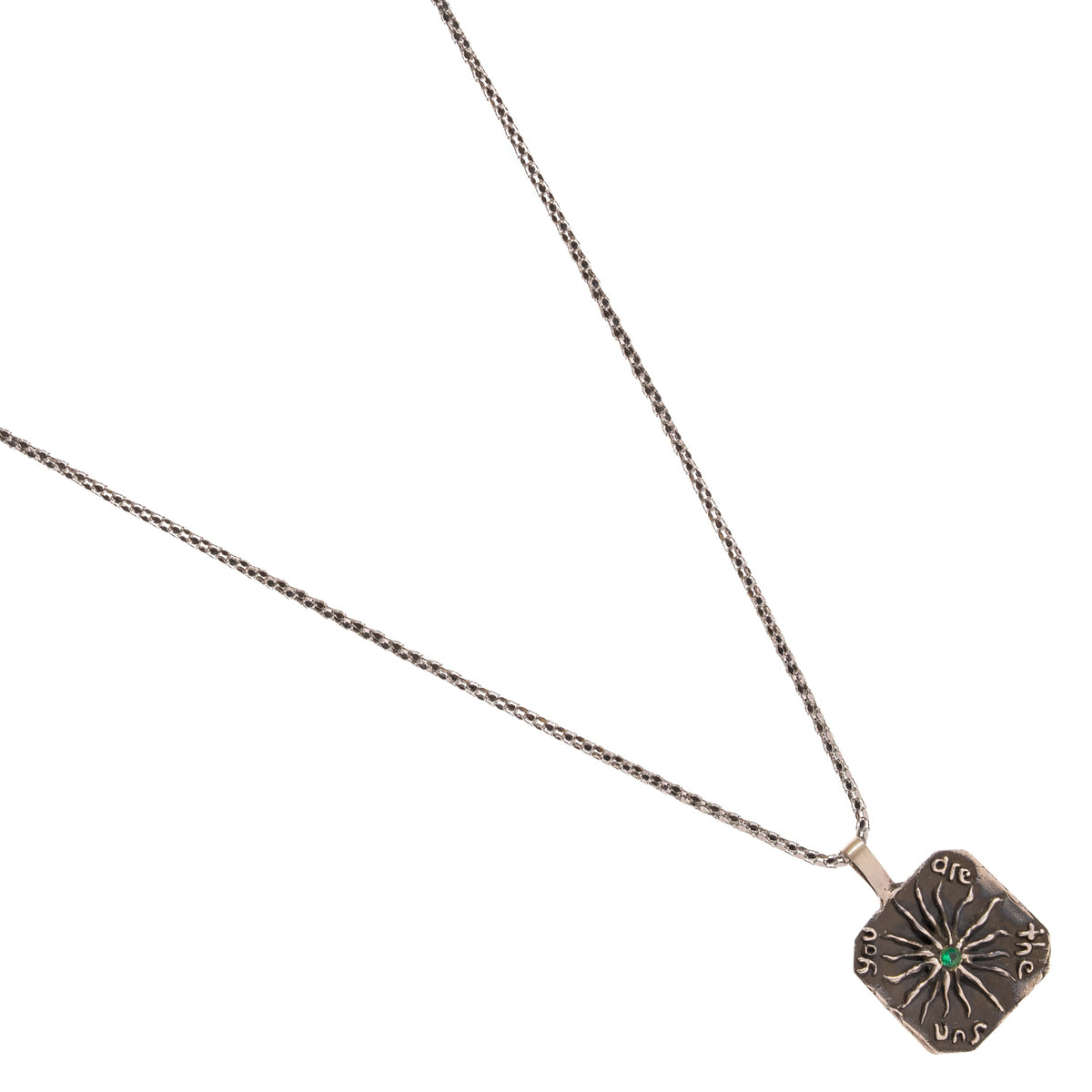 You Are The Sun emerald engraved silver pendant necklace laid at an angle on white
