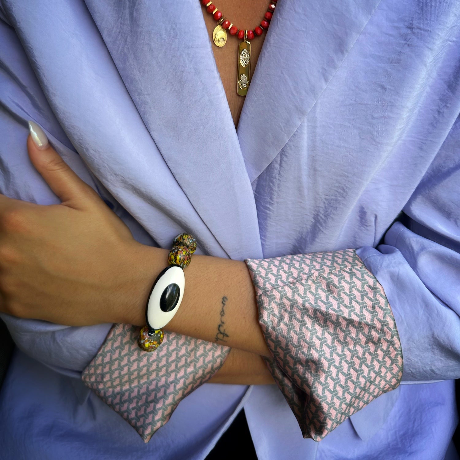 Model wearing African Chunky Eye Bracelet; Handmade chunky bracelet with black and white Nepal Eye bead, African beads, and yellow jade beads