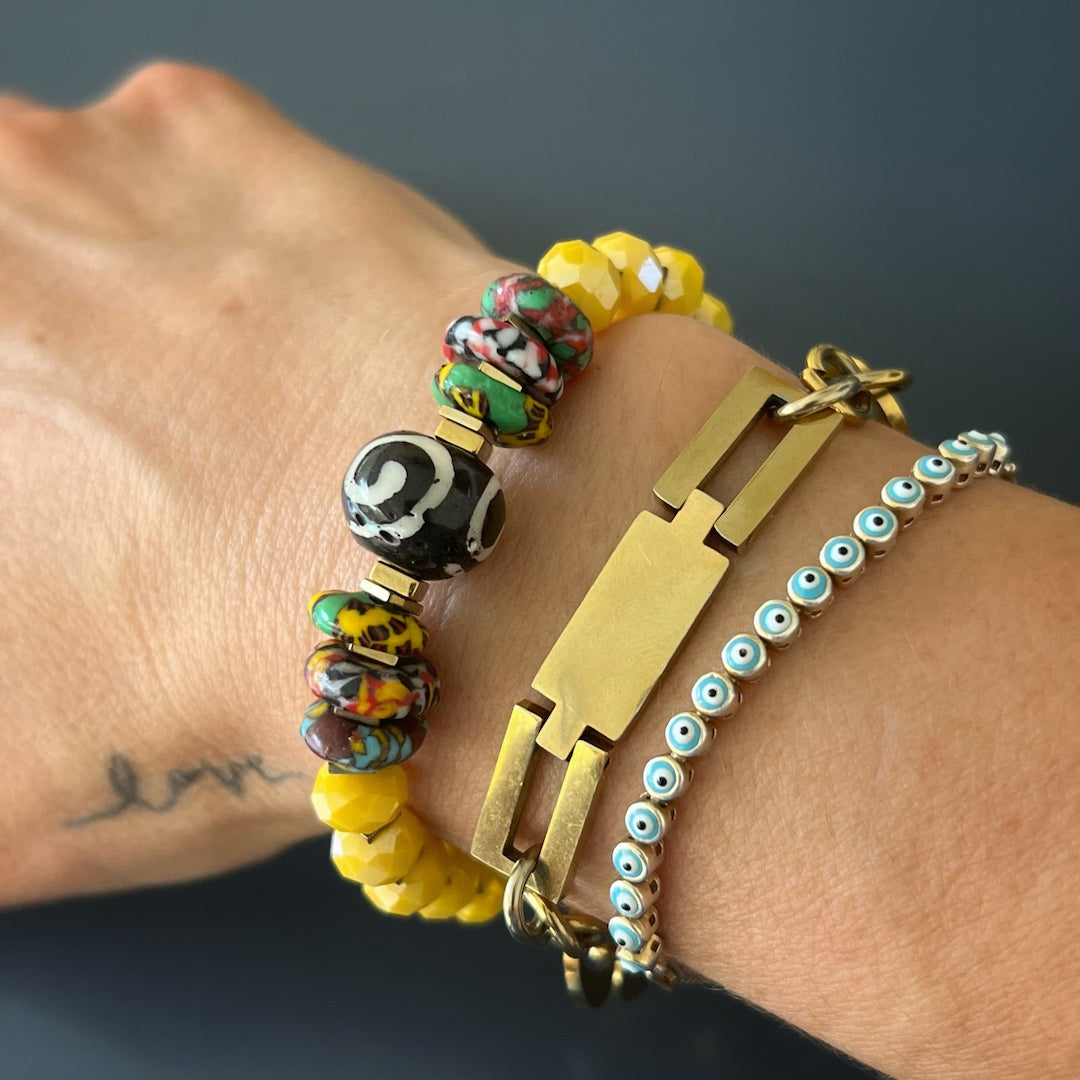 A model wearing african Yellow Women Bracelet and showing one-of-a-kind women-s accessories, demonstrating its versatility and ability to mix and match with various pieces