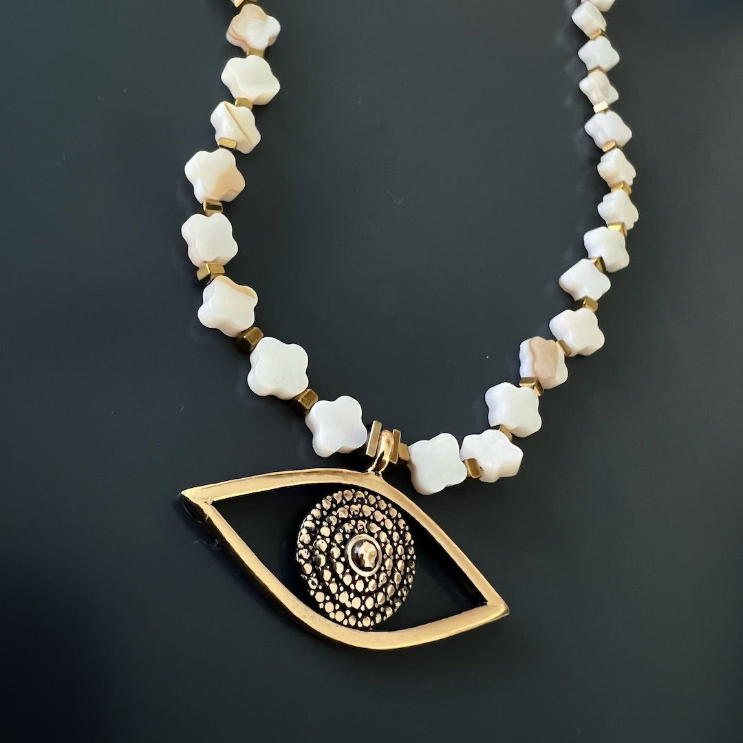 The Alhambra Evil Eye Choker Necklace is a beautiful and meaningful piece of jewelry that will enhance your style and help you feel protected, featuring elegant gold plated hematite spacers and a stunning Evil Eye charm.