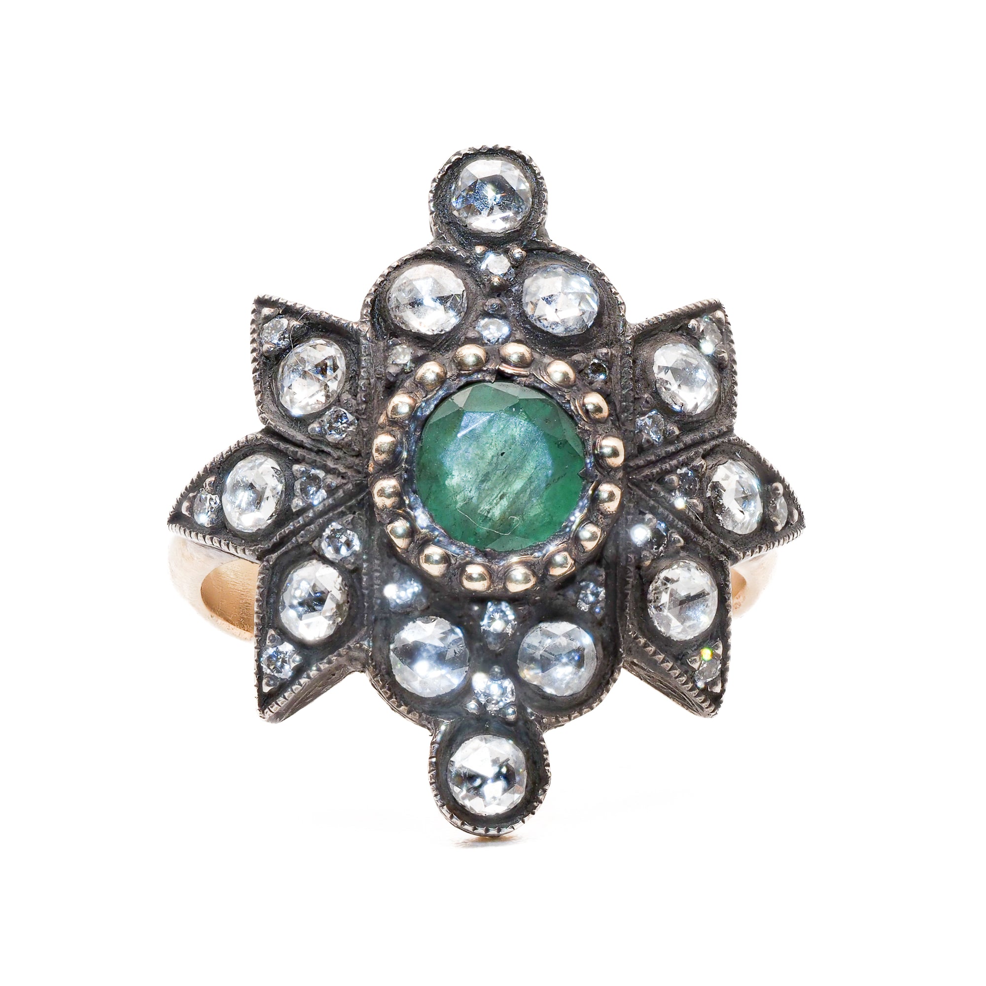 The Emerald Star Ring features a stunning 0.53ct natural emerald surrounded by 0.66ct diamonds, set in a luxurious combination of 14k yellow and silver gold.