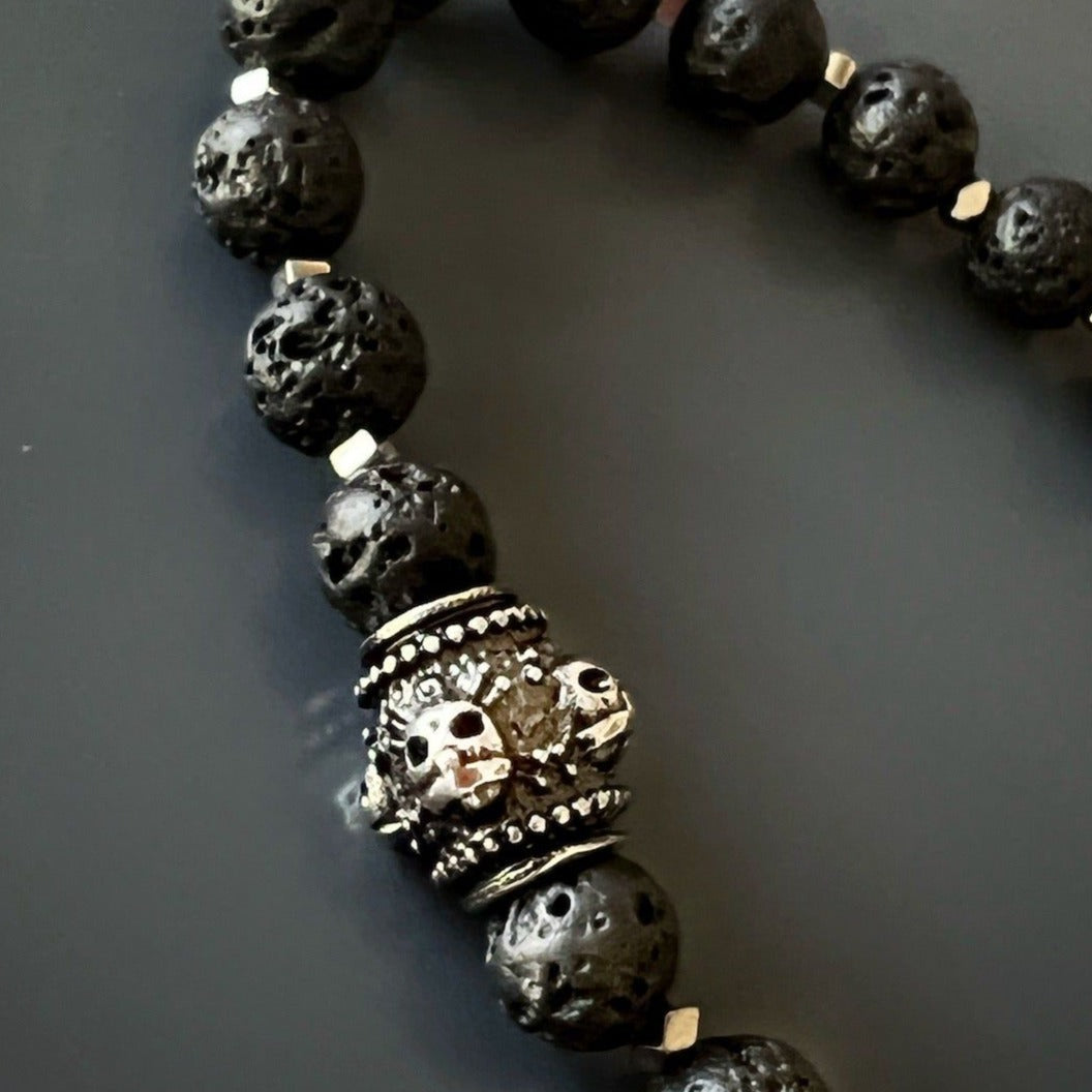 The black lava rock beads are believed to have grounding properties, providing the wearer with a sense of stability and balance.