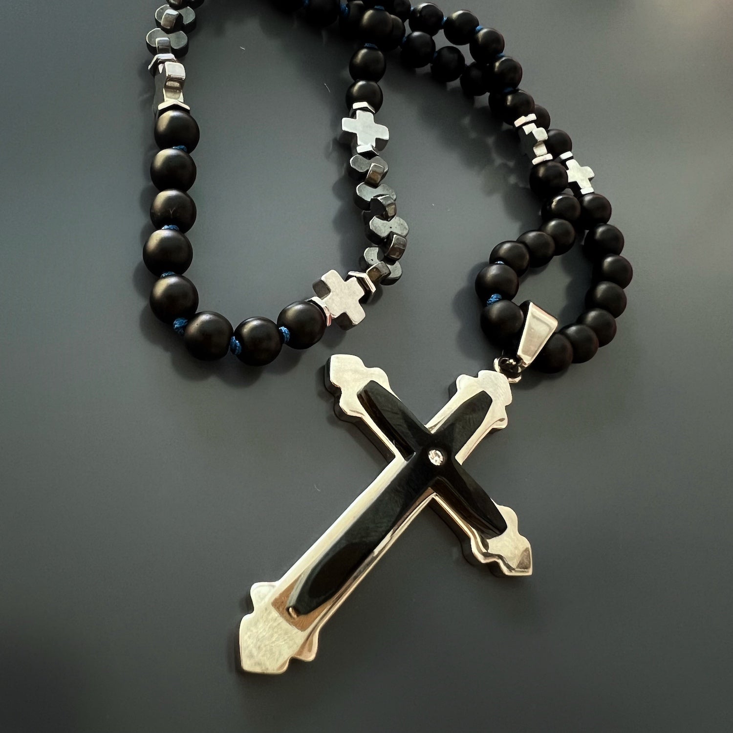 Black Onyx Cross Necklace on black background