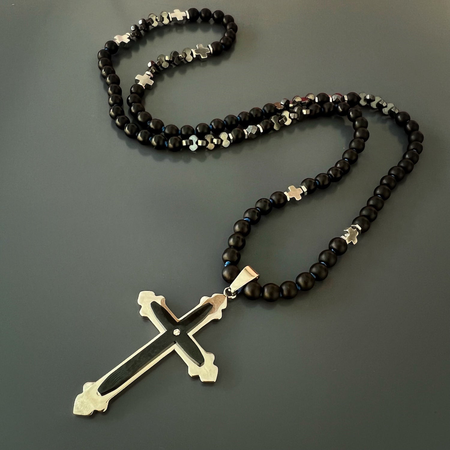 Spiritual Black Onyx Cross Necklace on Neutral Background