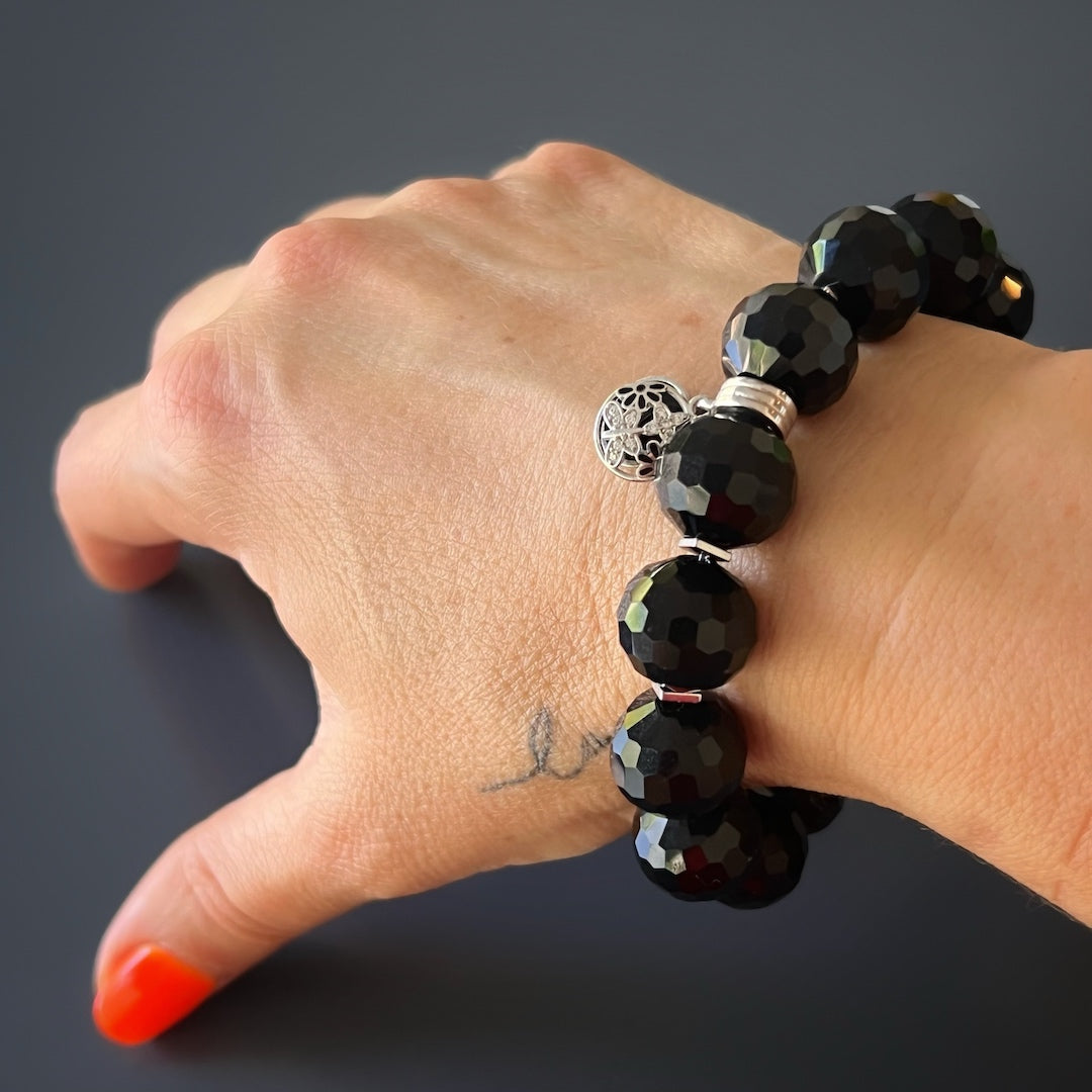 Hand model showcasing the Black Protection Bracelet with Onyx Stone and Swarovski Crystal