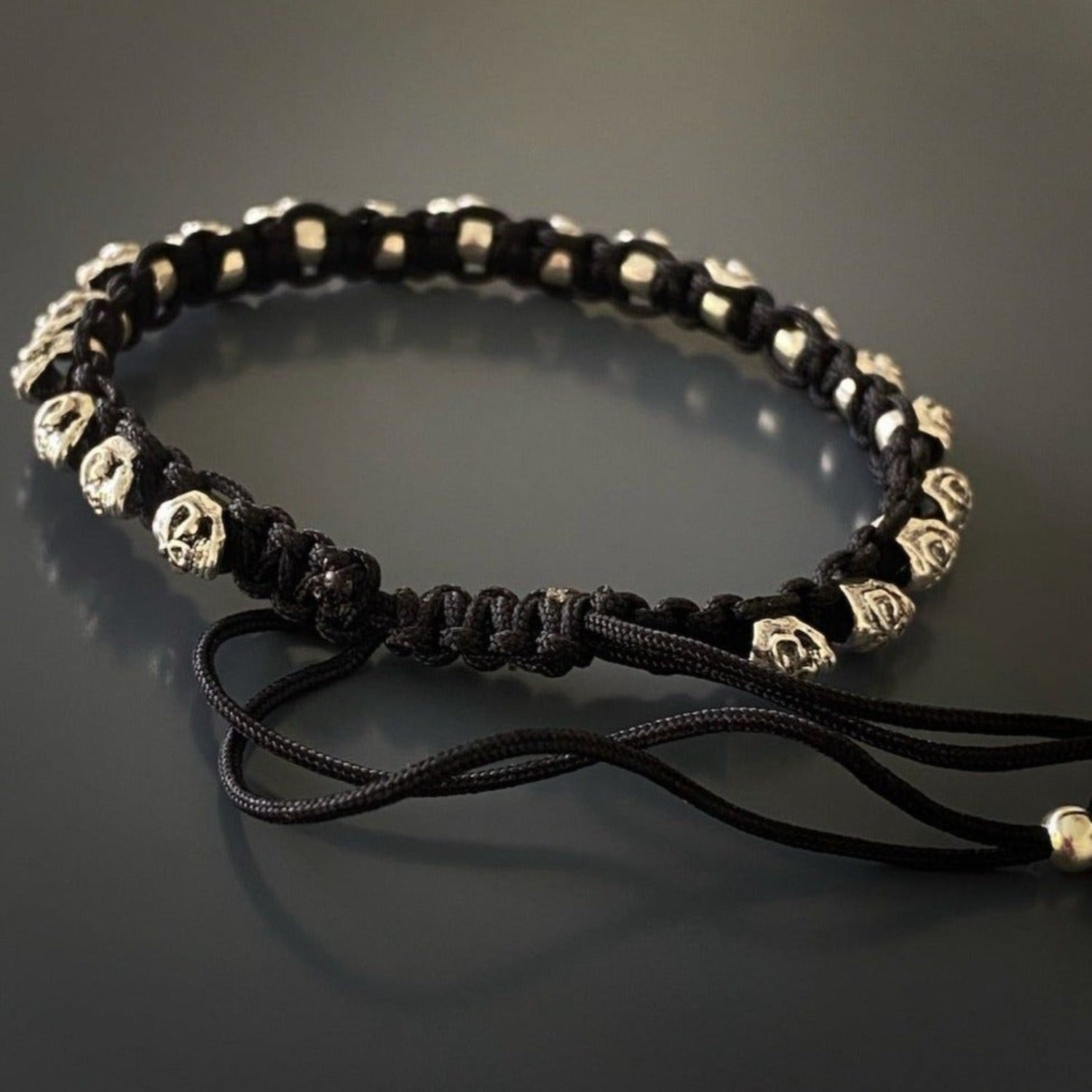 The black knotted rope adds a touch of edginess to the design.