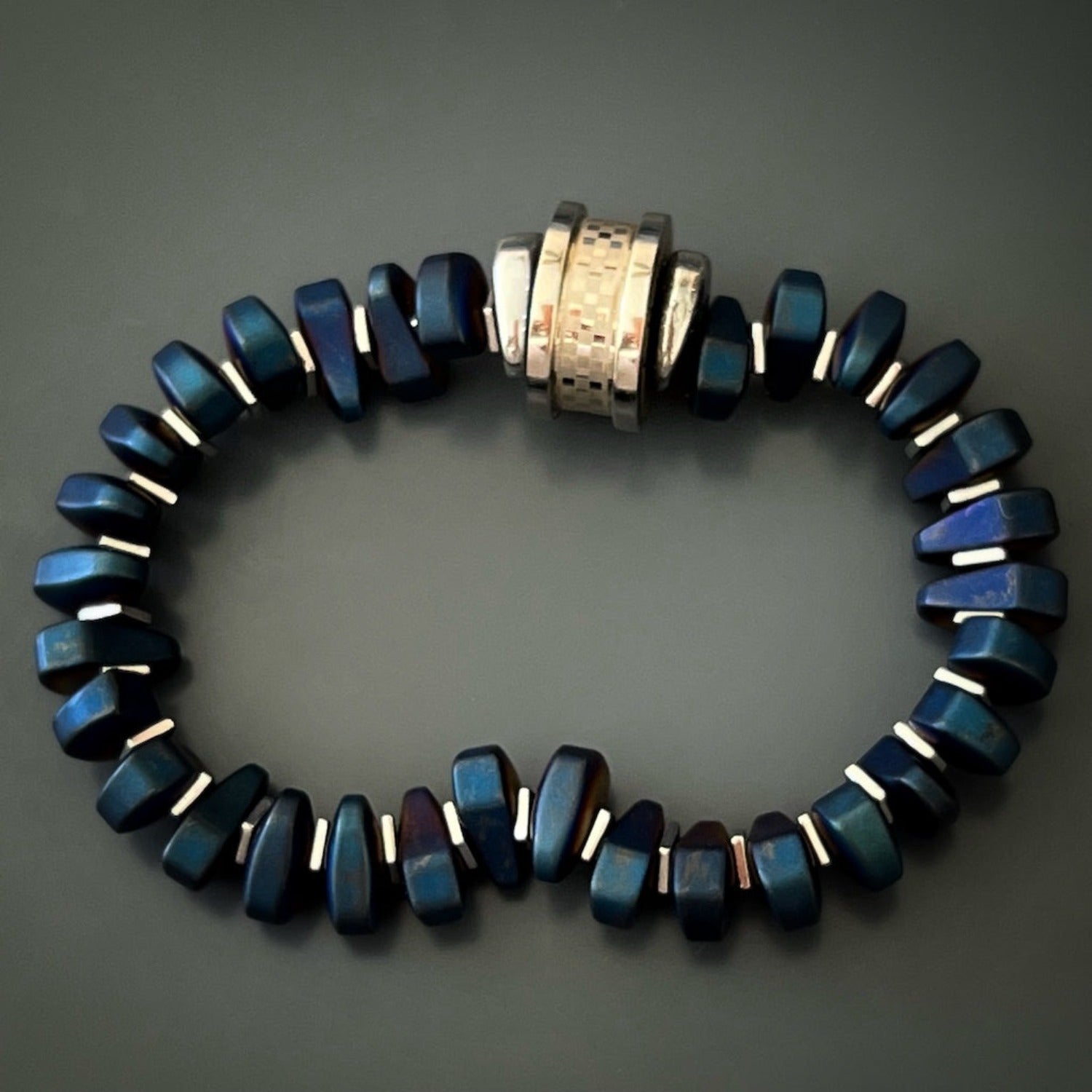 The unique and sleek stainless steel amour charm bead on the Blue Amour Men Bracelet
