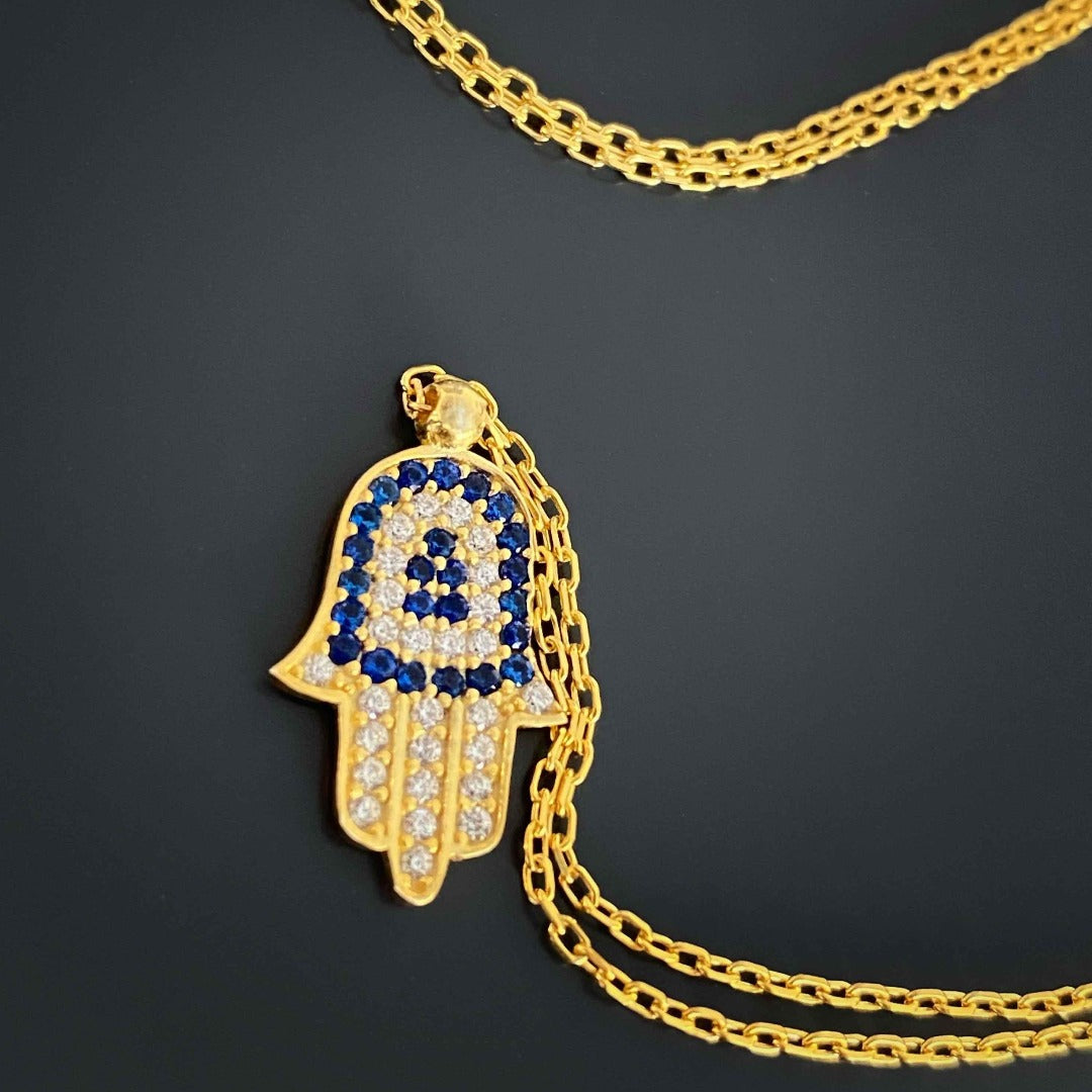 Close-up of Blue and Gold Minimal Hamsa Necklace with CZ Diamond stones