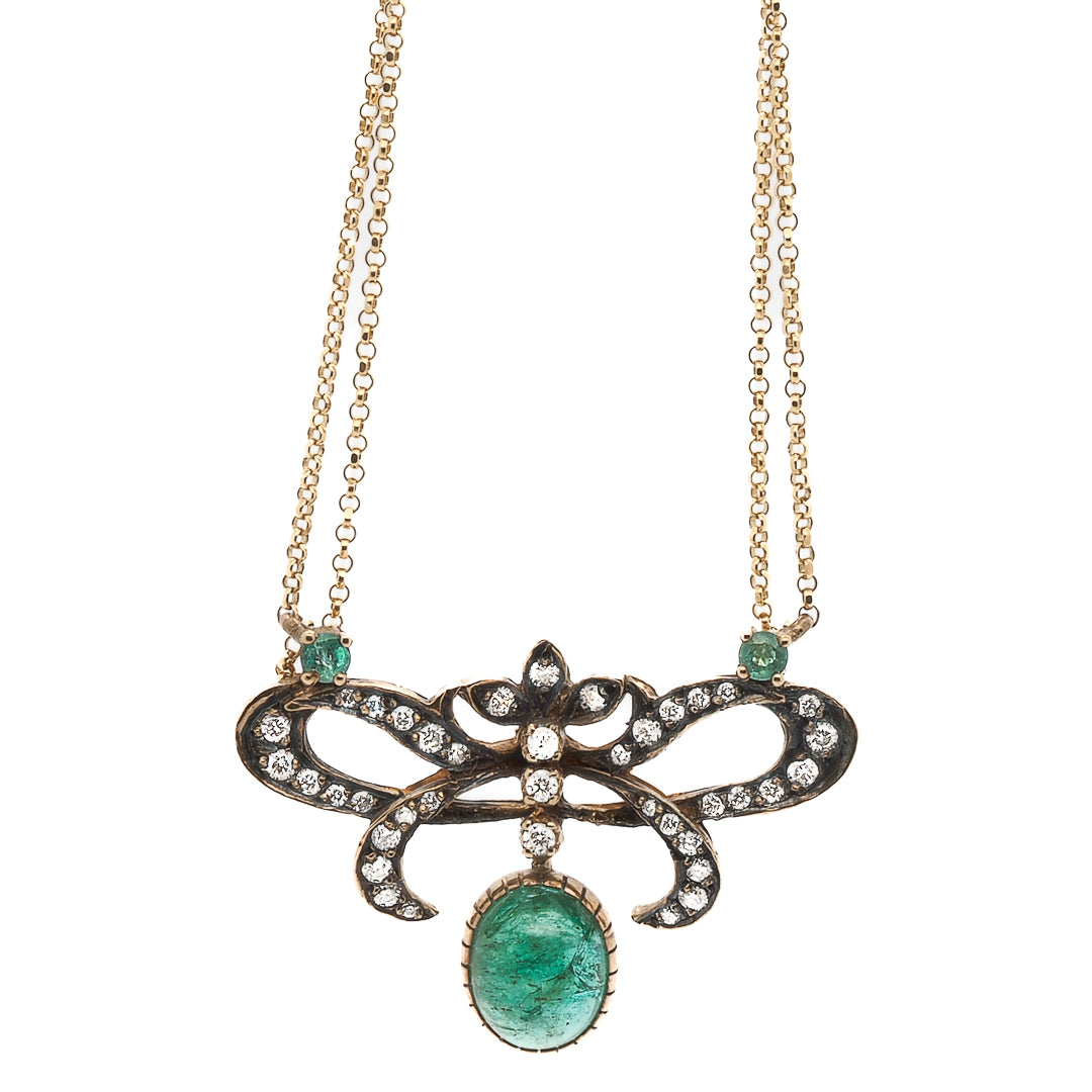 This necklace features a gorgeous emerald stone that symbolizes fidelity and true love, set in 14K yellow gold and accented with sparkling diamonds.