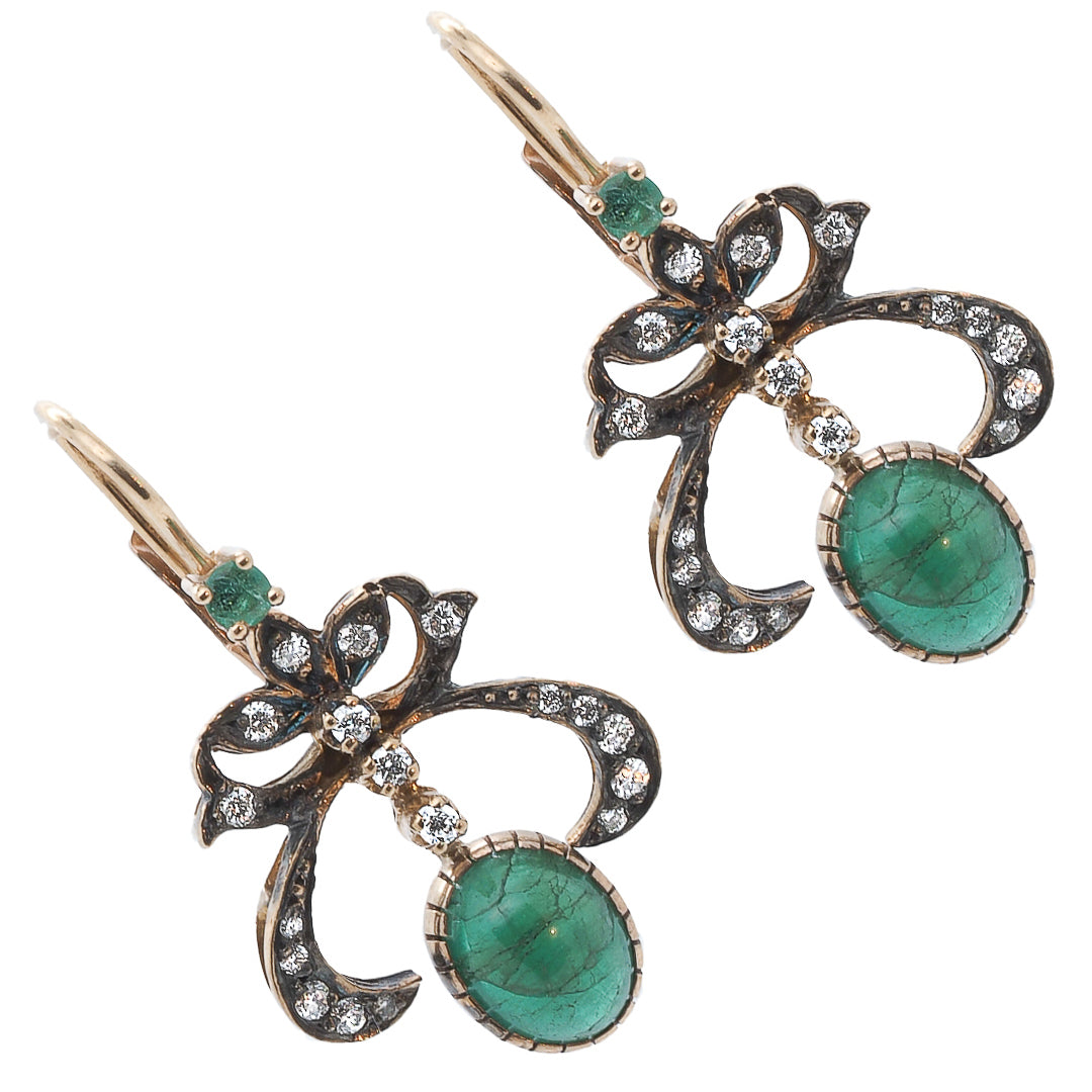 Cabochon Emerald Earrings adding a touch of elegance and sophistication to any outfit.