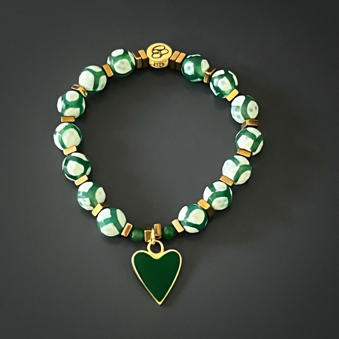 Featuring Nepal Agate beads and gold hematite clover leaf beads, this bracelet set exudes a delicate and feminine charm. The 18K gold-plated green enamel heart charm and white enamel heart bead add a touch of elegance and grace to this exquisite design.