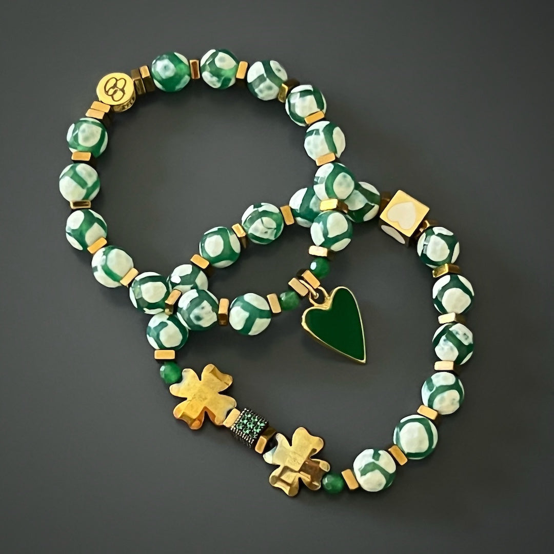 The combination of Nepal Agate beads, gold hematite clover leaf beads, and a playful mix of 18K gold-plated green enamel heart charm and white enamel heart bead creates a stylish and whimsical bracelet set. It is a perfect accessory to express your unique personality and add a touch of joy to your outfit.