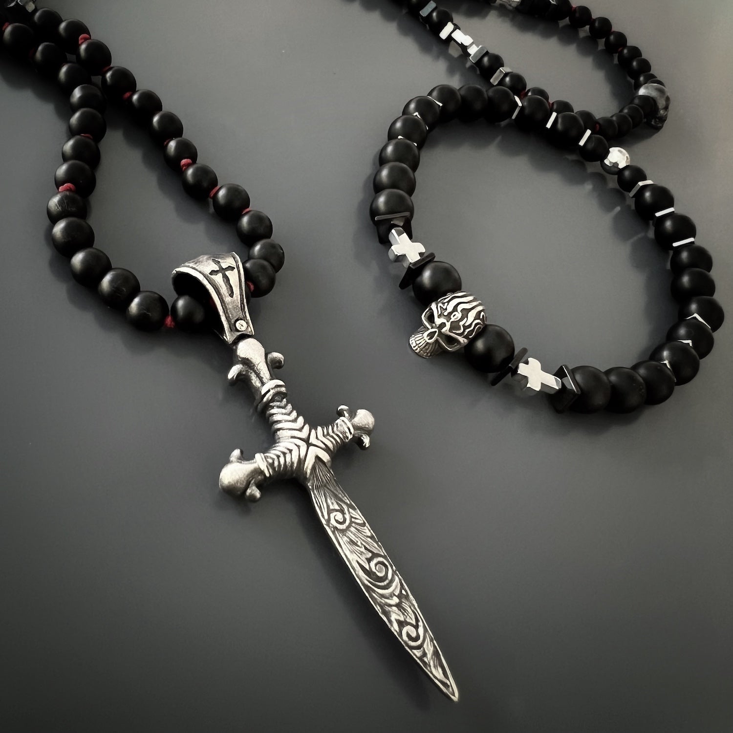 the Courage Onyx Skull Bracelet, beautifully highlighting its black onyx stones, sterling silver skull bead, and silver hematite cross beads. 