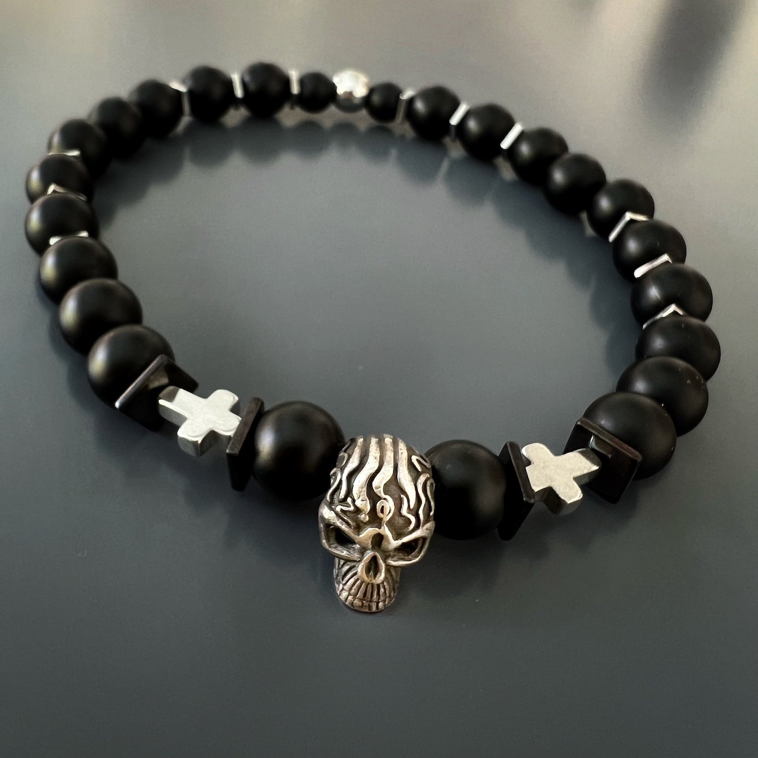 The Courage Onyx Skull Bracelet is a stunning handmade piece that embodies courage and fearlessness. 