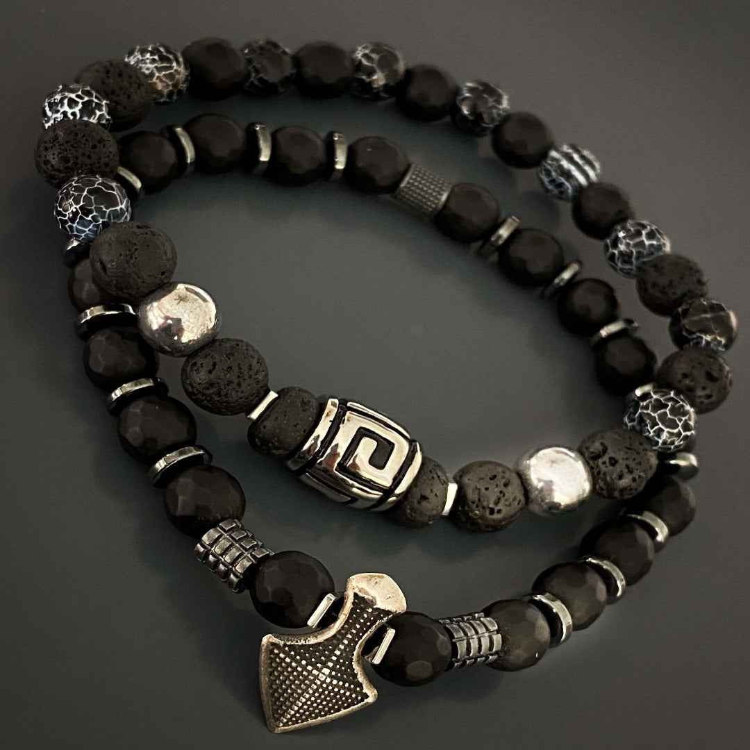 The Courage Lava Rock Men&#39;s Bracelet combines black lava rock and crackle agate stone beads for a stylish and meaningful accessory. Handcrafted with care, this bracelet is designed to inspire fearlessness and inner strength. The silver hematite beads add a touch of sophistication to the overall design.