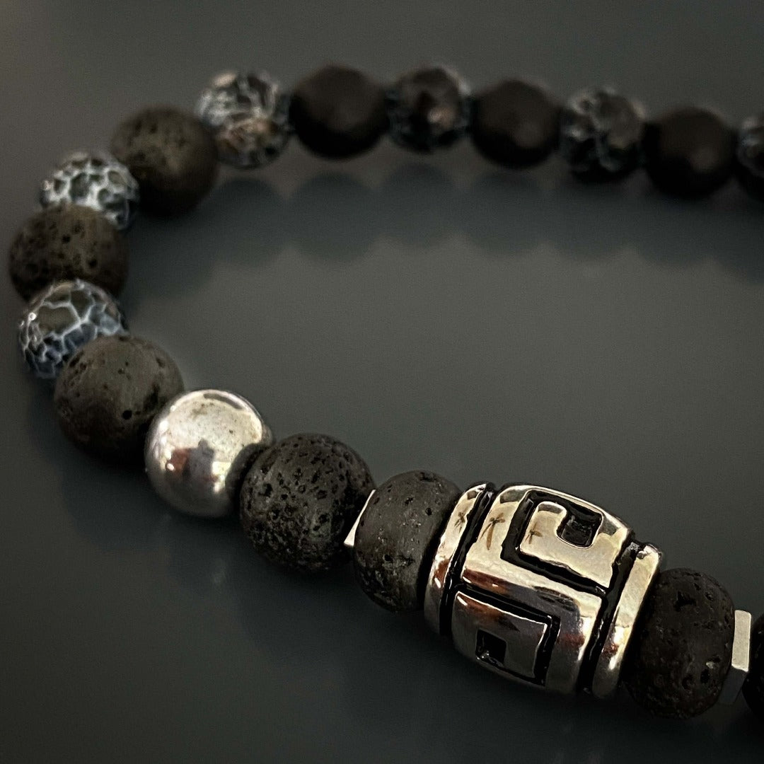 Elevate your style with the Courage Lava Rock Men&#39;s Bracelet. Handcrafted with black lava rock and crackle agate stone beads, this bracelet exudes confidence and courage. The silver hematite beads add a touch of sophistication to this meaningful accessory.