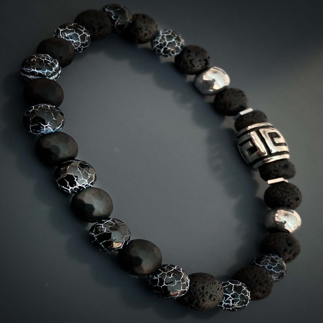 The Courage Lava Rock Men's Bracelet is a symbol of strength and fearlessness. Handmade with black lava rock and crackle agate stone beads, this bracelet is designed to empower and inspire. The silver hematite beads provide a stylish accent to this meaningful accessory.
