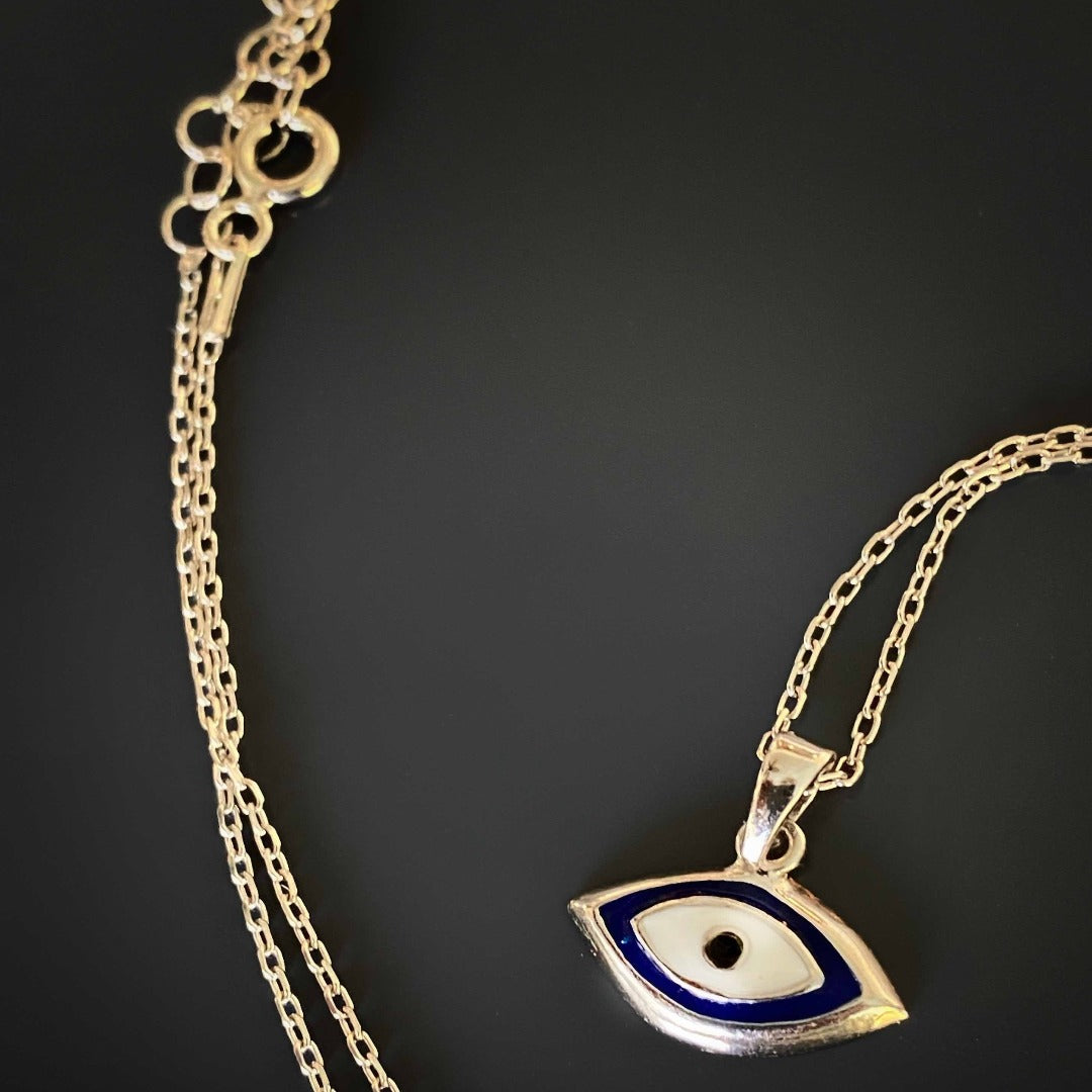 The Dainty Evil Eye Necklace styled on a neck, adding a touch of protection and symbolism to the overall look.