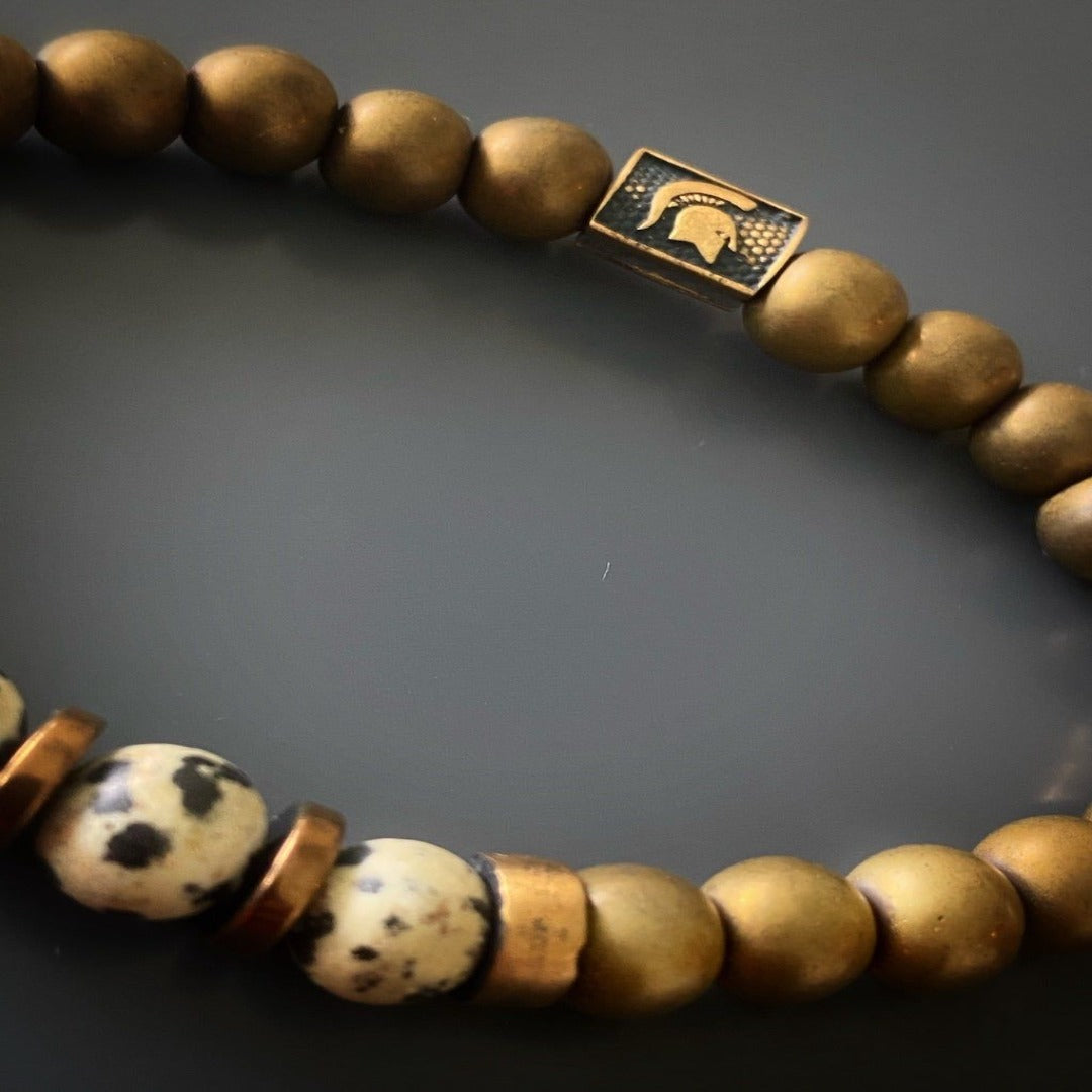 An image emphasizing the balancing properties of the Dalmatian jasper beads and the protective qualities of the hematite beads, symbolizing a harmonious and safe energy.