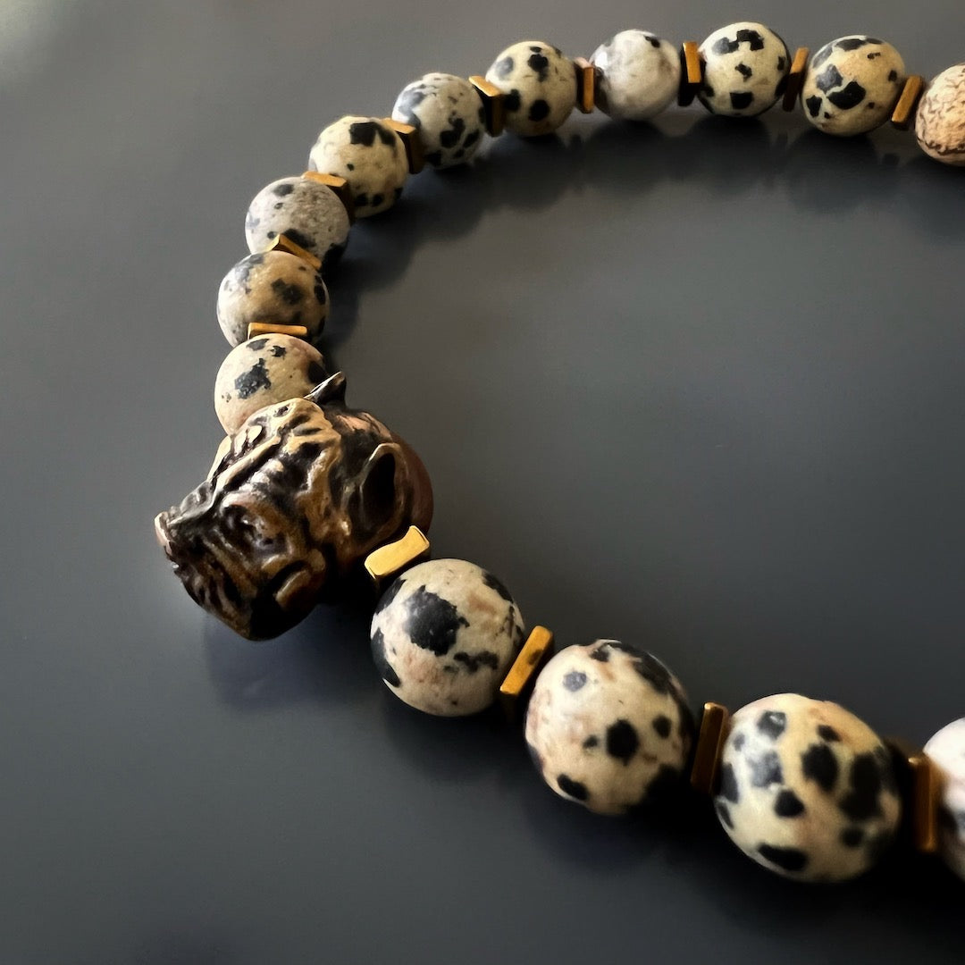 A close-up image of the Dalmatian Jasper Dog Bracelet, focusing on the bronze handmade dog charm, which represents the love and connection between humans and dogs.