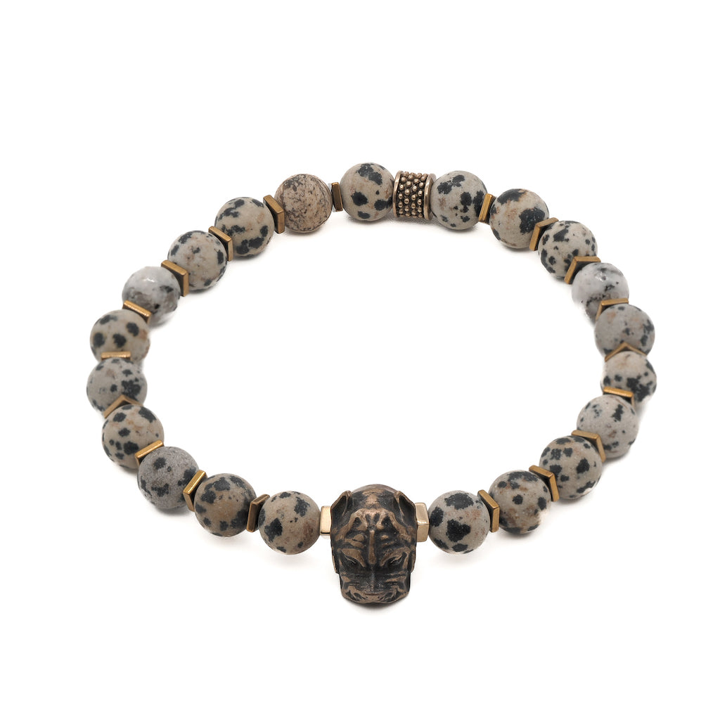 An image showcasing the Dalmatian Jasper Dog Bracelet, highlighting the beautiful handmade bronze dog charm, the dalmatian jasper stones, and the gold-colored Hematite stone spacers.