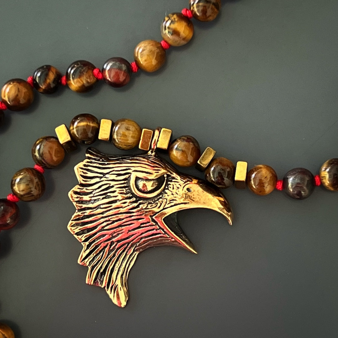 Eagle Spirit Necklace featuring Tiger&#39;s Eye beads and a handcrafted bronze pendant, representing freedom and confidence.