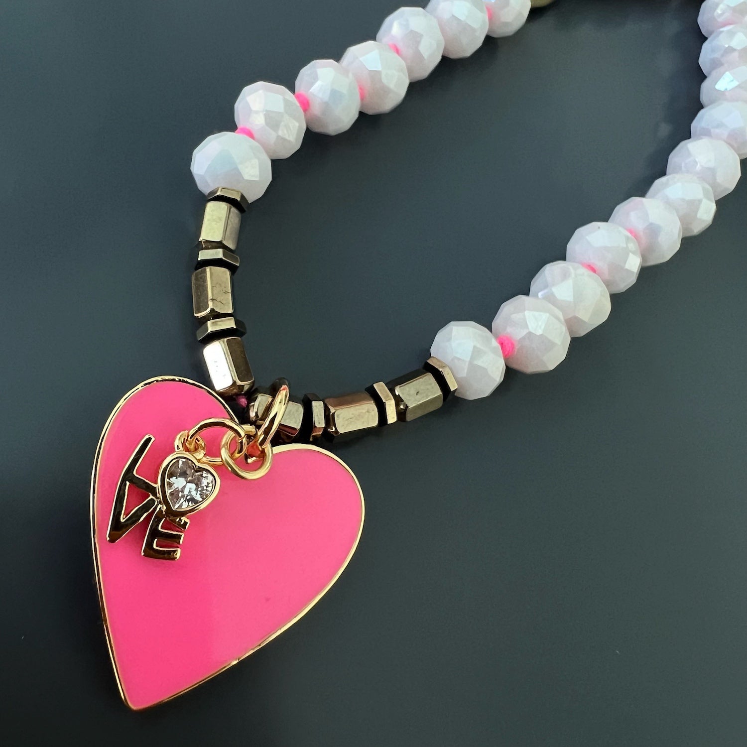 Detailed shot of the gold-colored hematite stone beads on the Eternal Love Necklace.