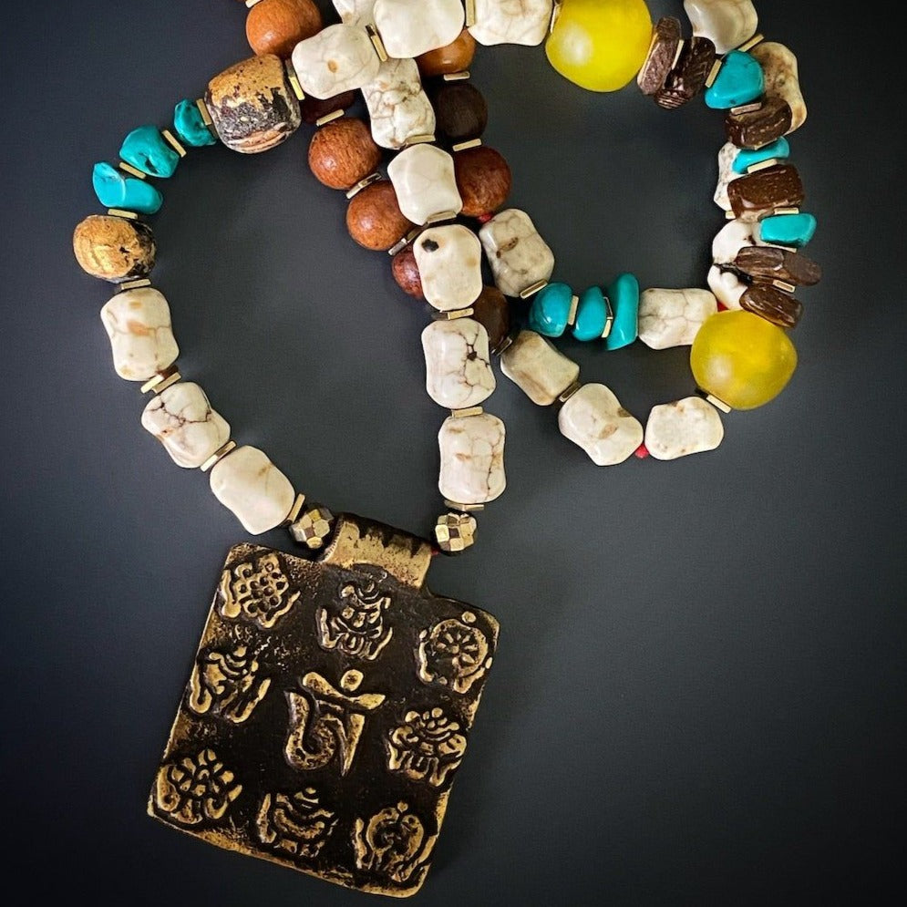 Cultural Heritage Necklace - A beautiful necklace that celebrates Nepal&#39;s rich cultural heritage. With its combination of Nepal meditation beads, African glass beads, and a unique Om Mantra pendant, this necklace is a symbol of spirituality and mindfulness.