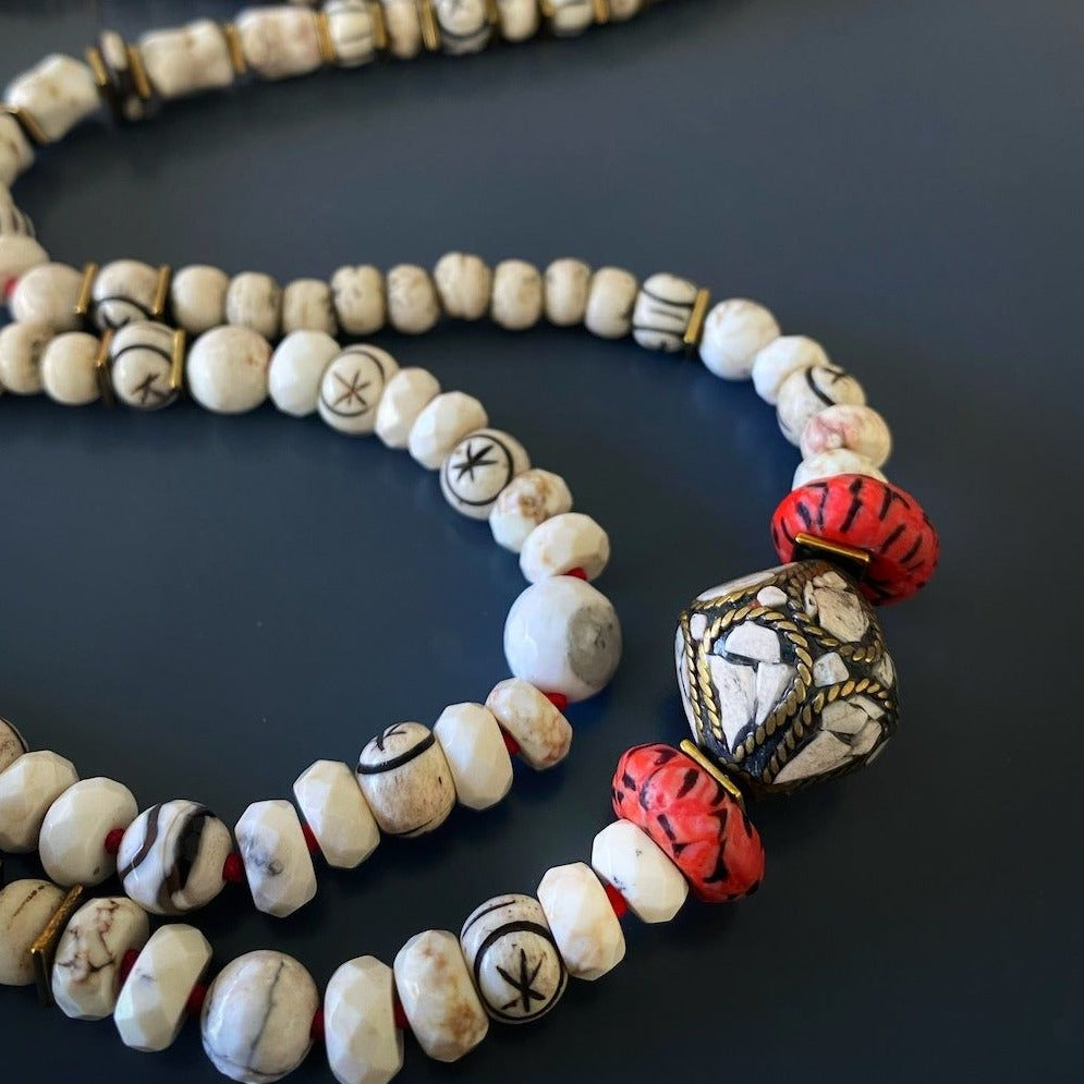 Featuring Nepal seed beads, African seed beads, and a unique red and gold Cross Pendant, this necklace is a symbol of cultural diversity and spirituality.