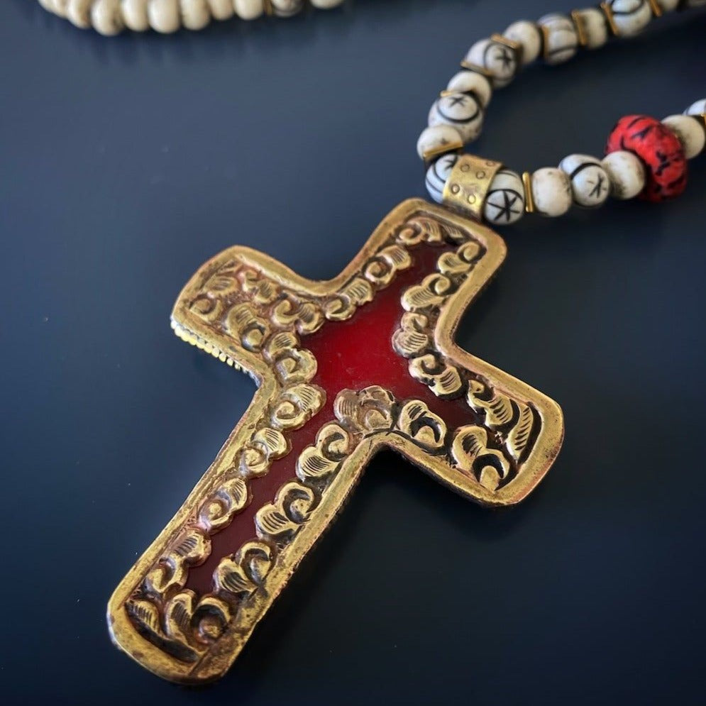 Vibrant Ethnic Necklace - A stunning display of the Ethnic Red Cross Necklace, showcasing the vibrant colors of the African seed beads and the bold red and gold Cross Pendant. 
