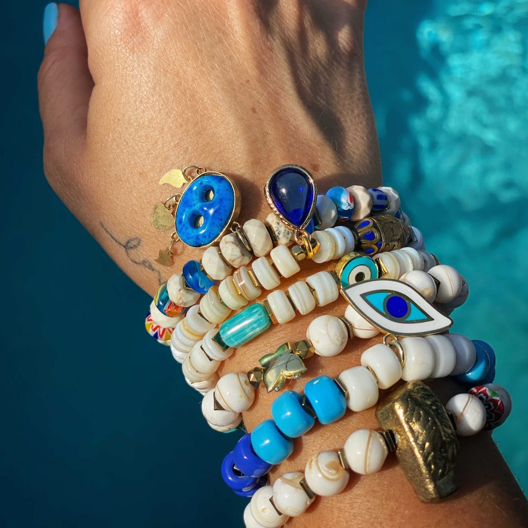 Stylish Bracelet Stack - A close-up of a hand model wearing the vibrant and stylish Ethnic Fashion Bracelet Set. 