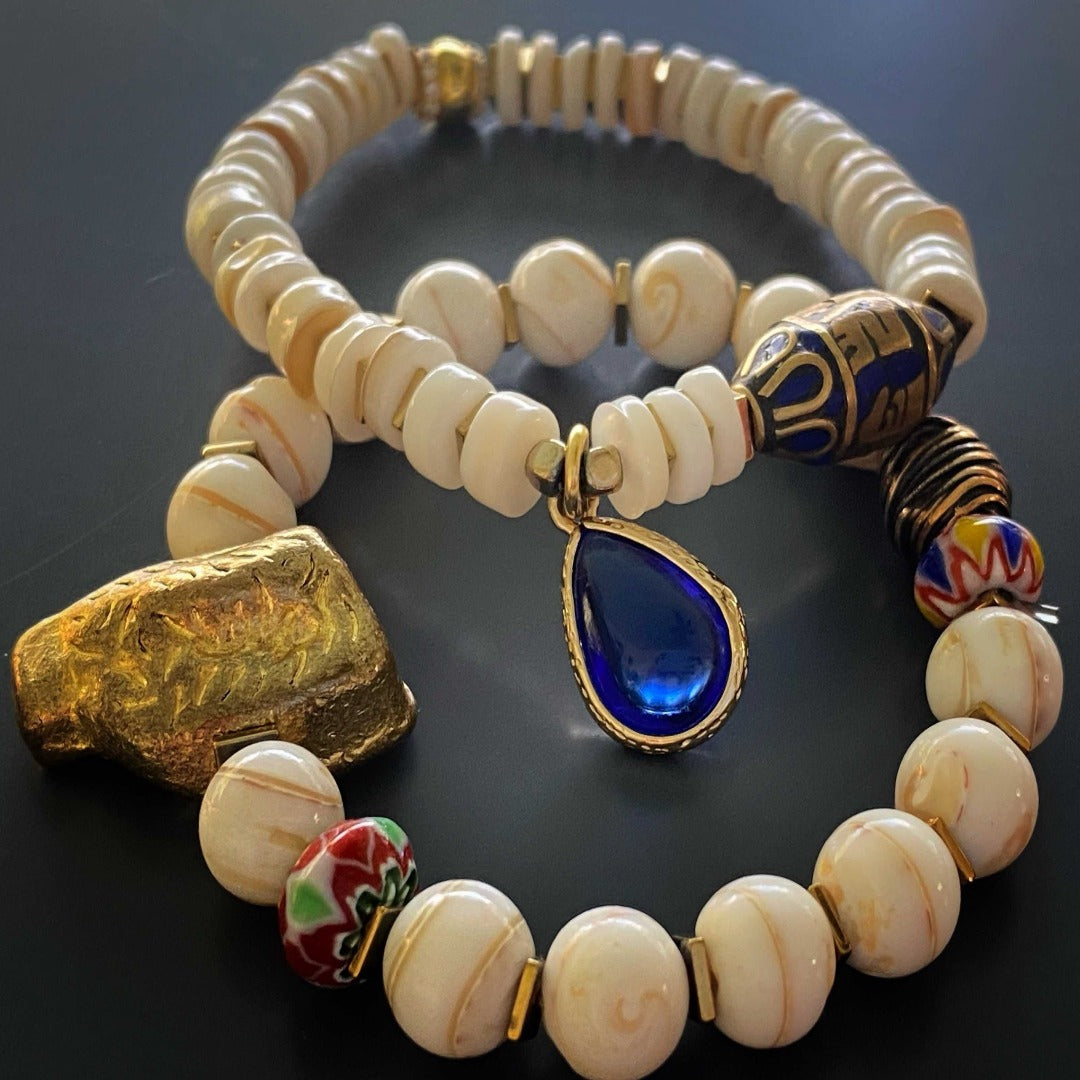 The unique combination of Nepal bone beads, colorful handmade African beads, and the brass handmade bead adds a touch of ethnic charm to any outfit.