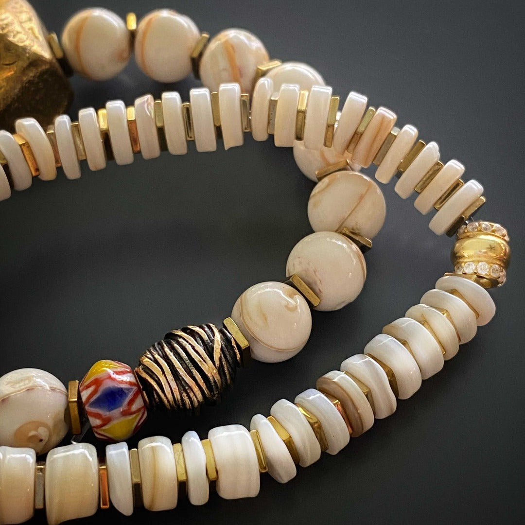 With a mix of gold-plated accents, natural shell beads, and the intricate Nepal Om mani padme hum mantra bead, this set is a true reflection of cultural diversity.