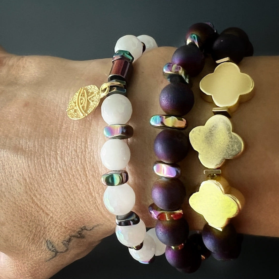 Fleur de Li Agate Bracelet on Hand Model - Handcrafted with Hematite and Druzy Agate stone beads, featuring a bronze on gold plated Fleur de li charm for a touch of history.