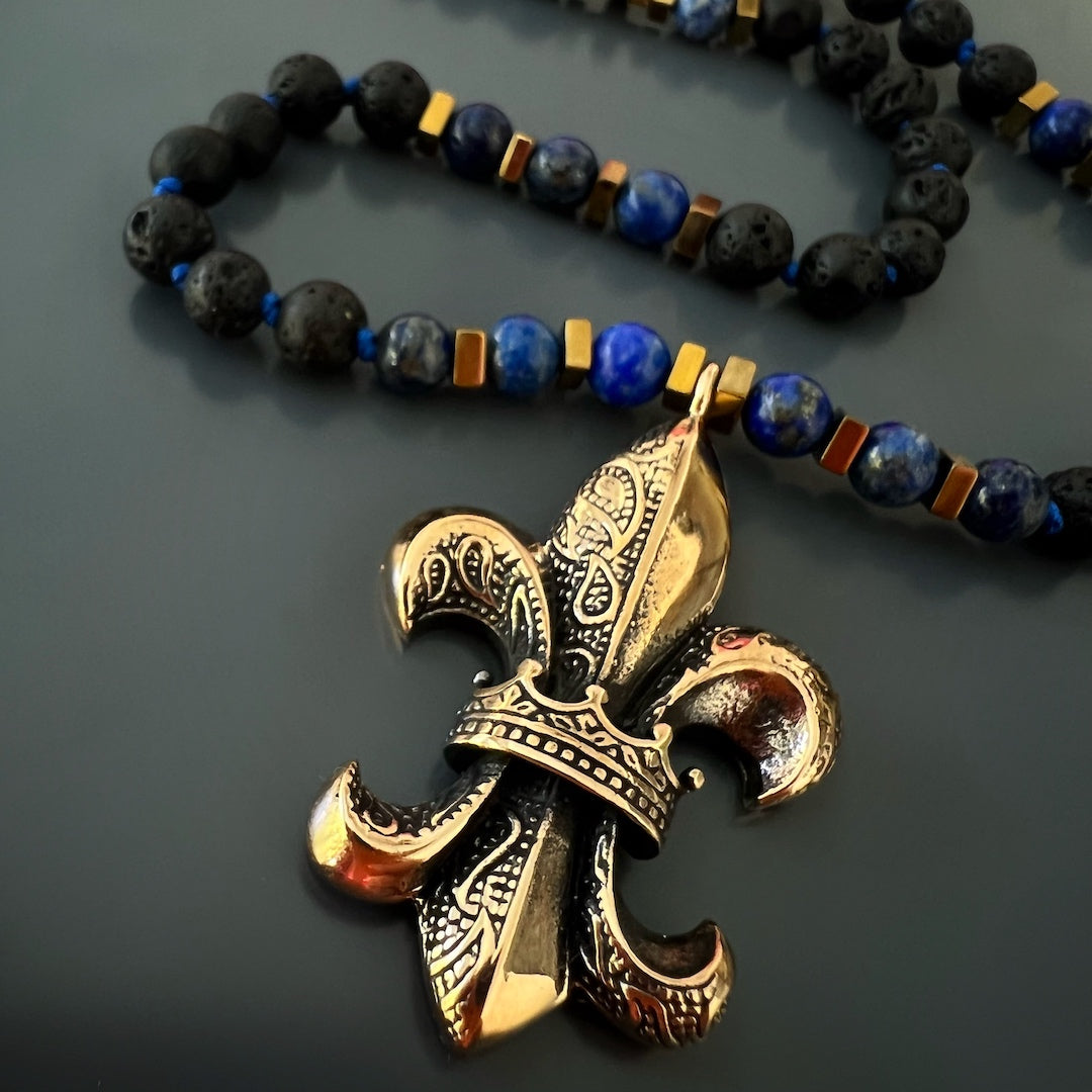 Spiritual Fleur de Lis Necklace - Handcrafted accessory featuring lava rock and lapis lazuli beads, and a handmade bronze pendant, providing emotional stability and guidance in complex situations