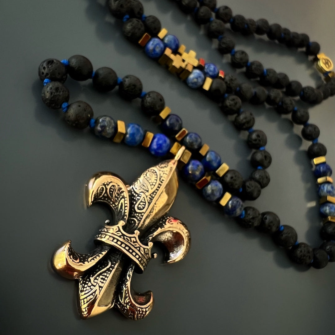 Fleur de Lis Beaded Necklace - Handcrafted jewelry with lava rock and lapis lazuli stone beads, and a bronze pendant, offering a unique and meaningful addition to your style.