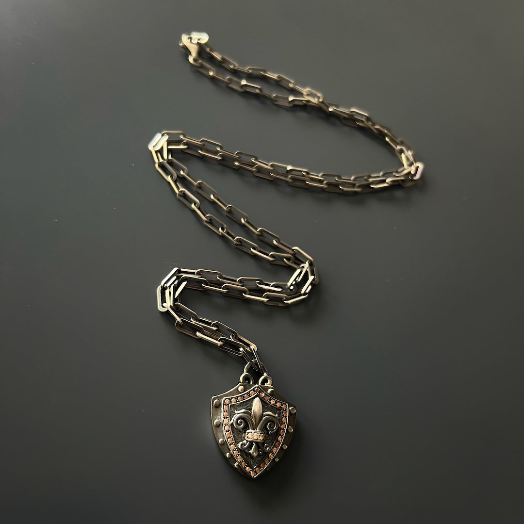 Handmade Fleur de Lis Shield Pendant Necklace - Unique accessory featuring a meticulously crafted 925 silver pendant with engraved details and brown zircon stones