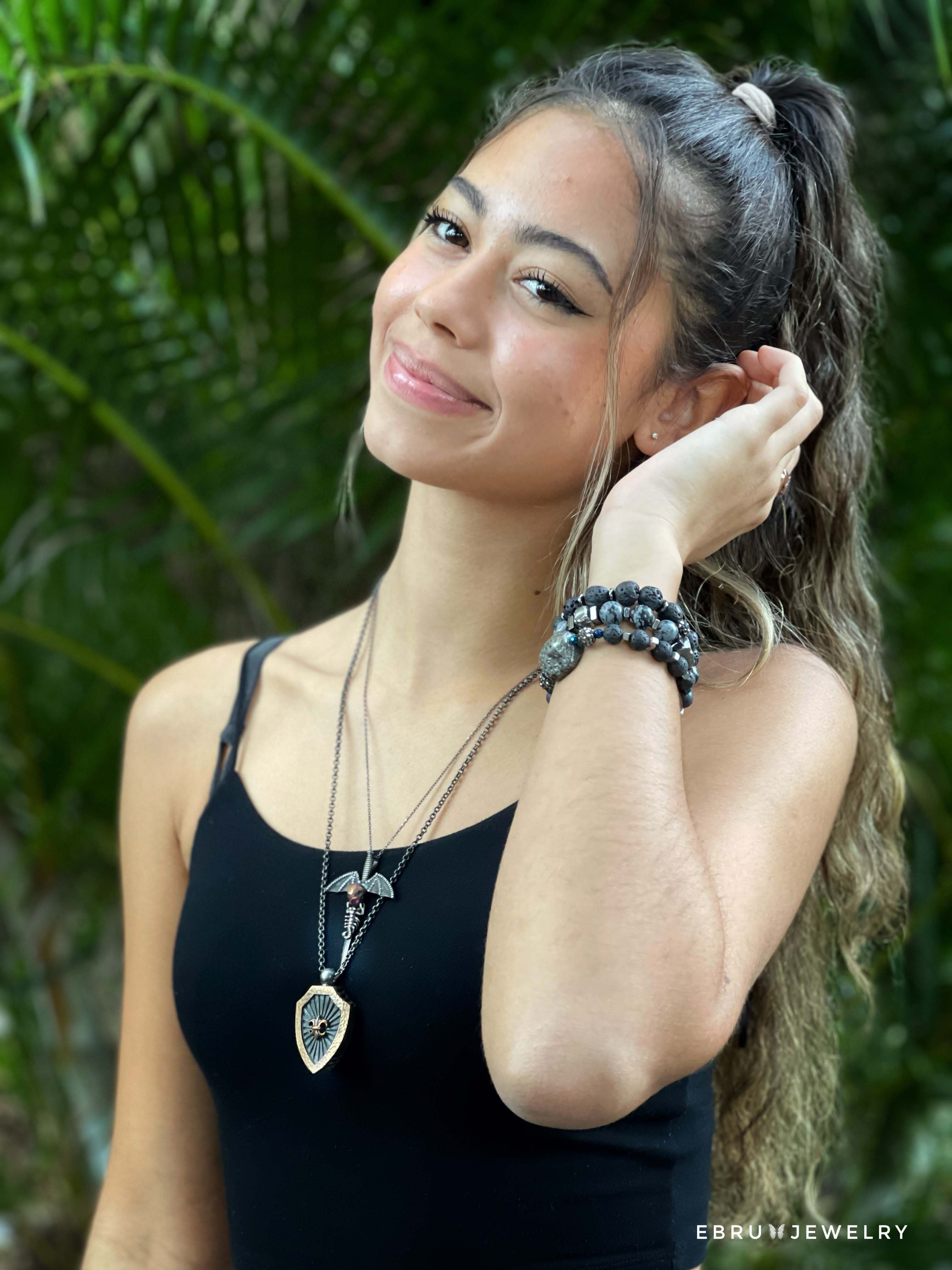 Elegant Model wearing Fleur de Lis Necklace - Meticulously crafted accessory with a sterling silver chain and beautifully designed pendant, radiating grace and purpose.